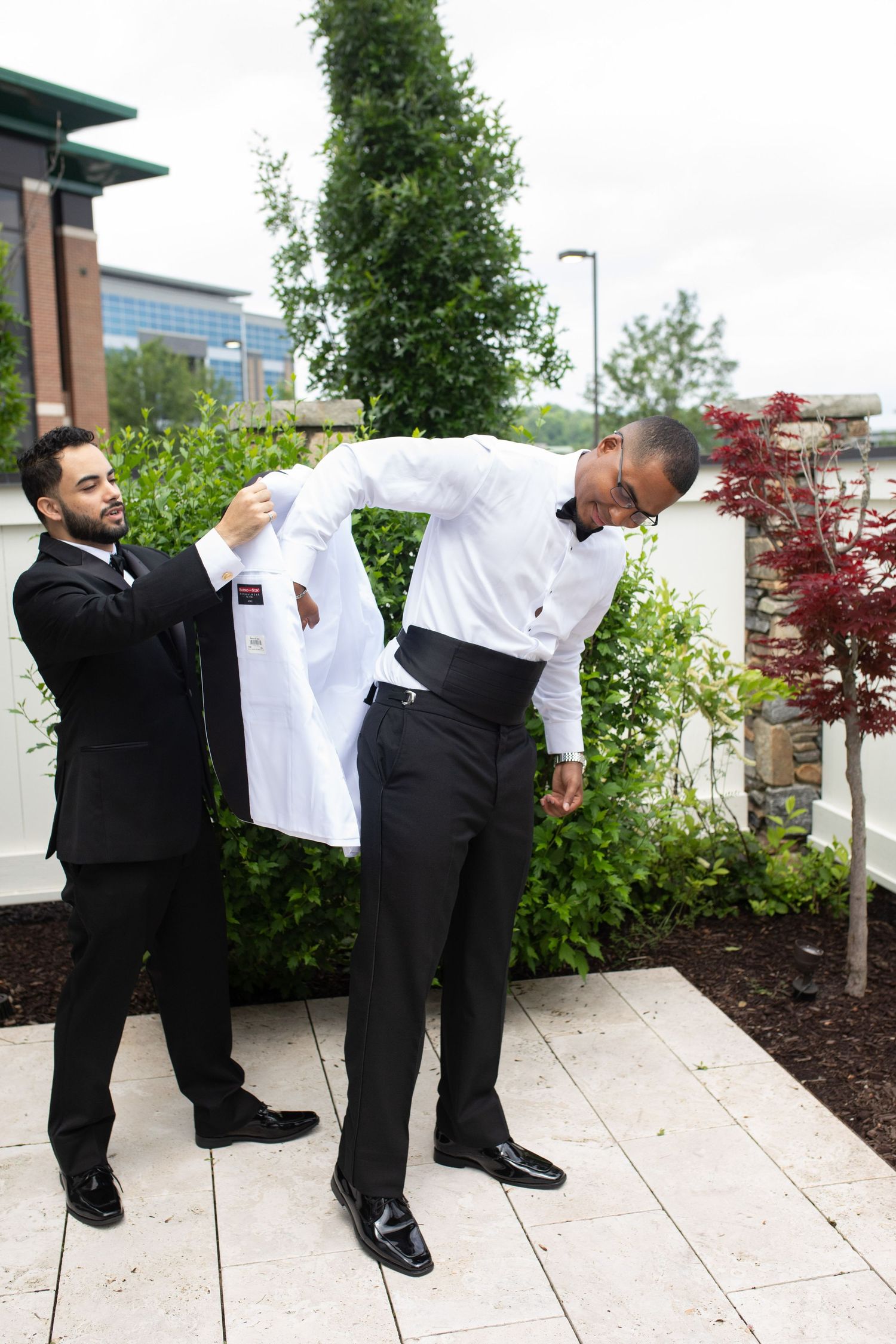 Wedding party members strike funny poses in a series of outdoor shots.