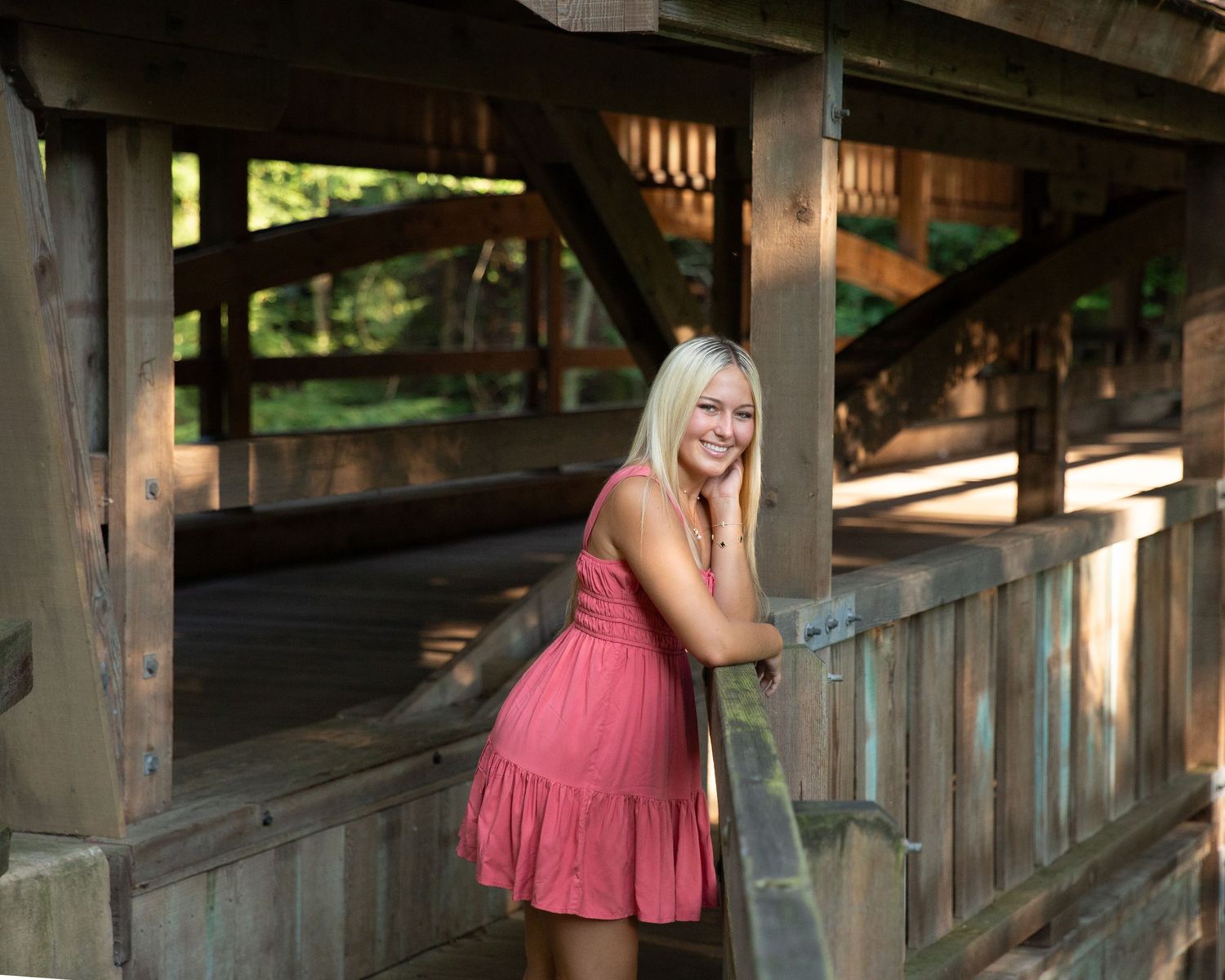 Wooden covered bridge or walkway with rustic beams and architectural details.