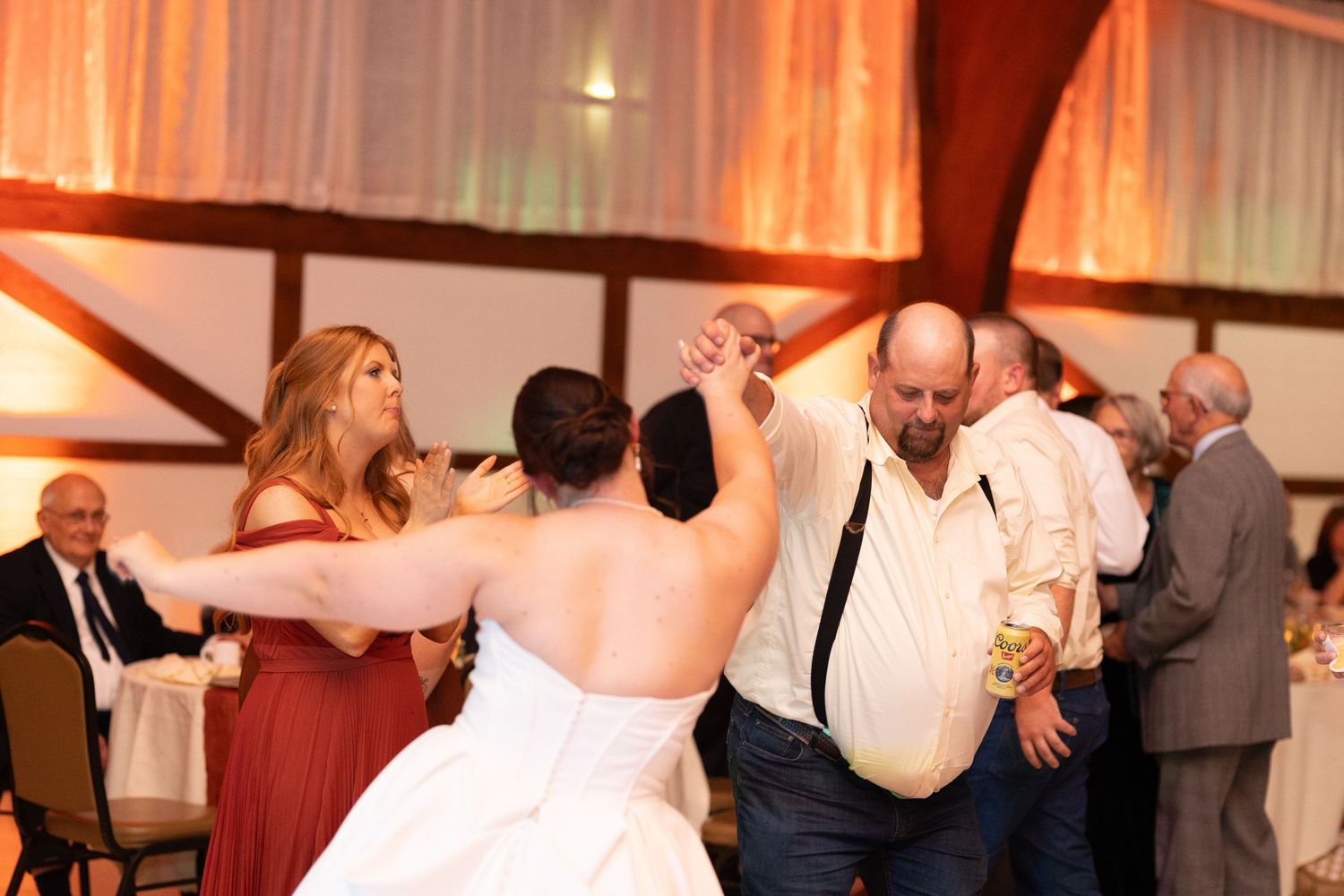Wedding reception dance floor filled with guests enjoying the celebration.