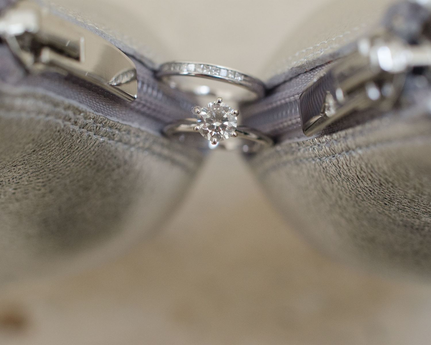 Close-up of diamond engagement ring with gray ribbon detail.
