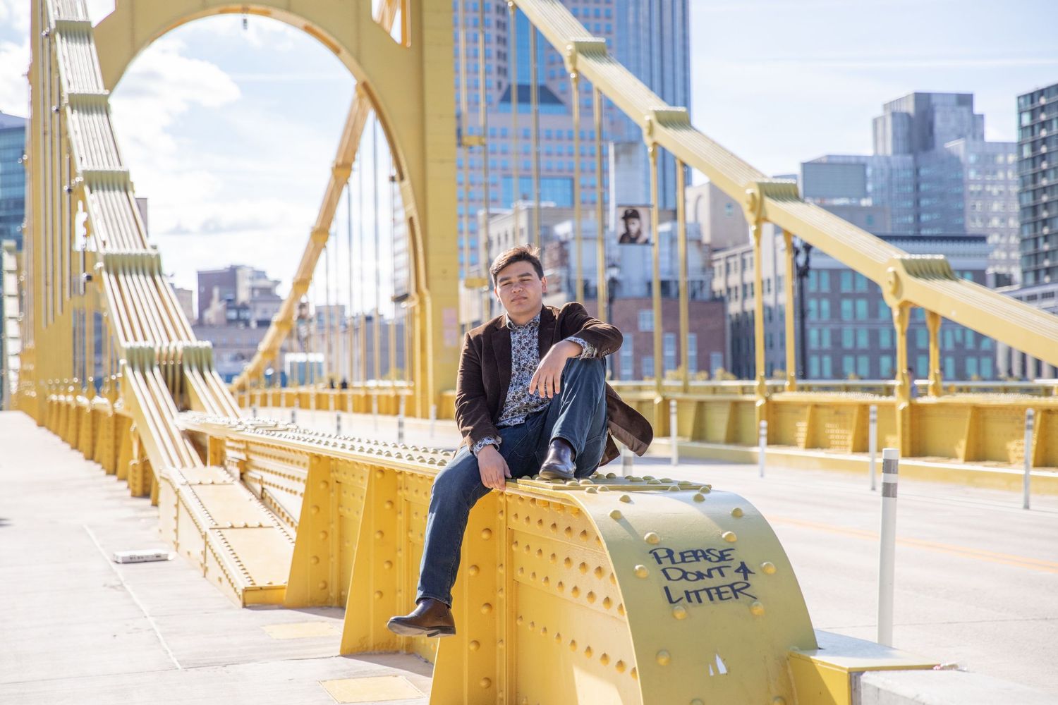 View of Pittsburgh's iconic yellow bridges and downtown buildings along the riverfront.