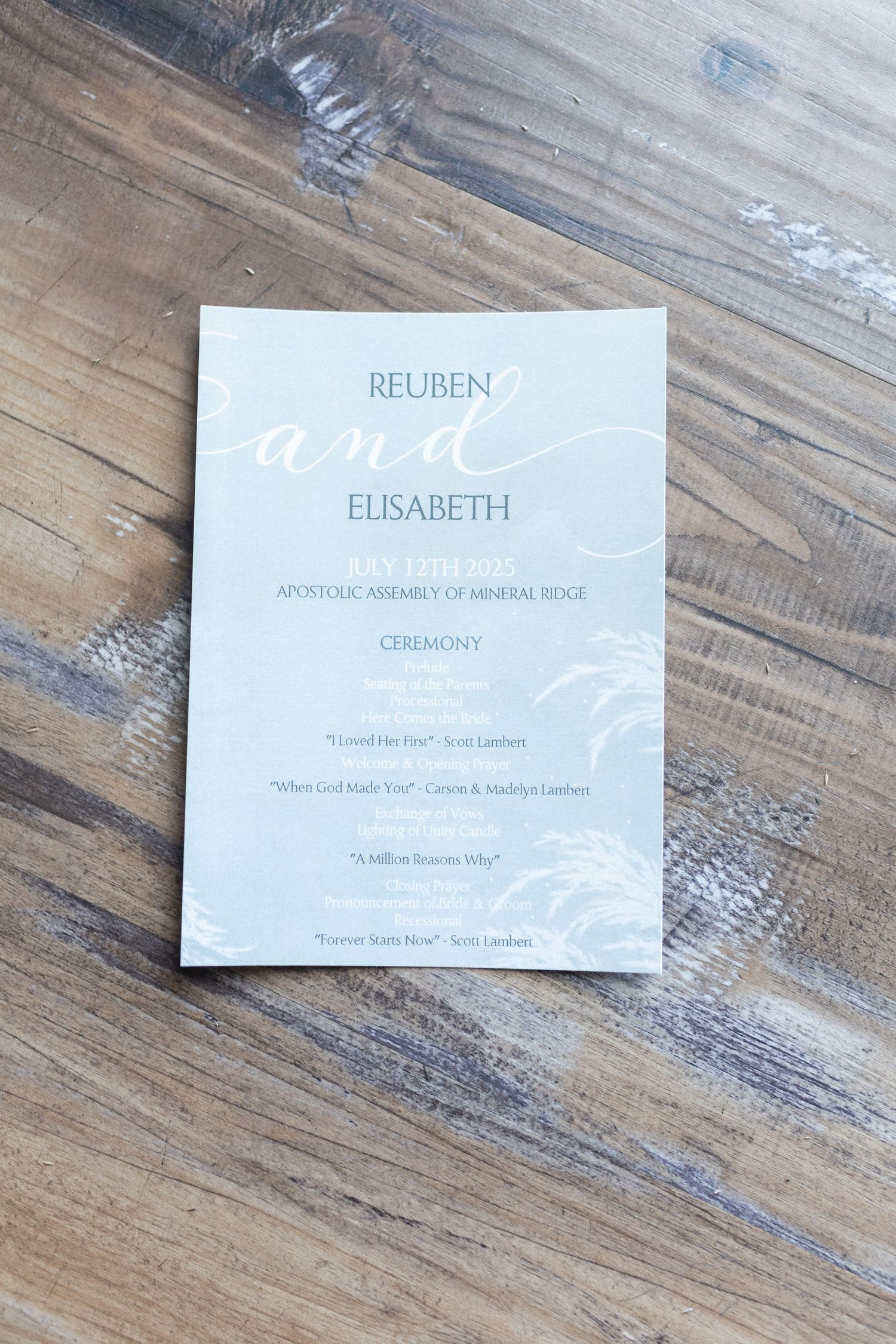 A wedding invitation for Reuben and Elisabeth printed in white text on light gray paper.