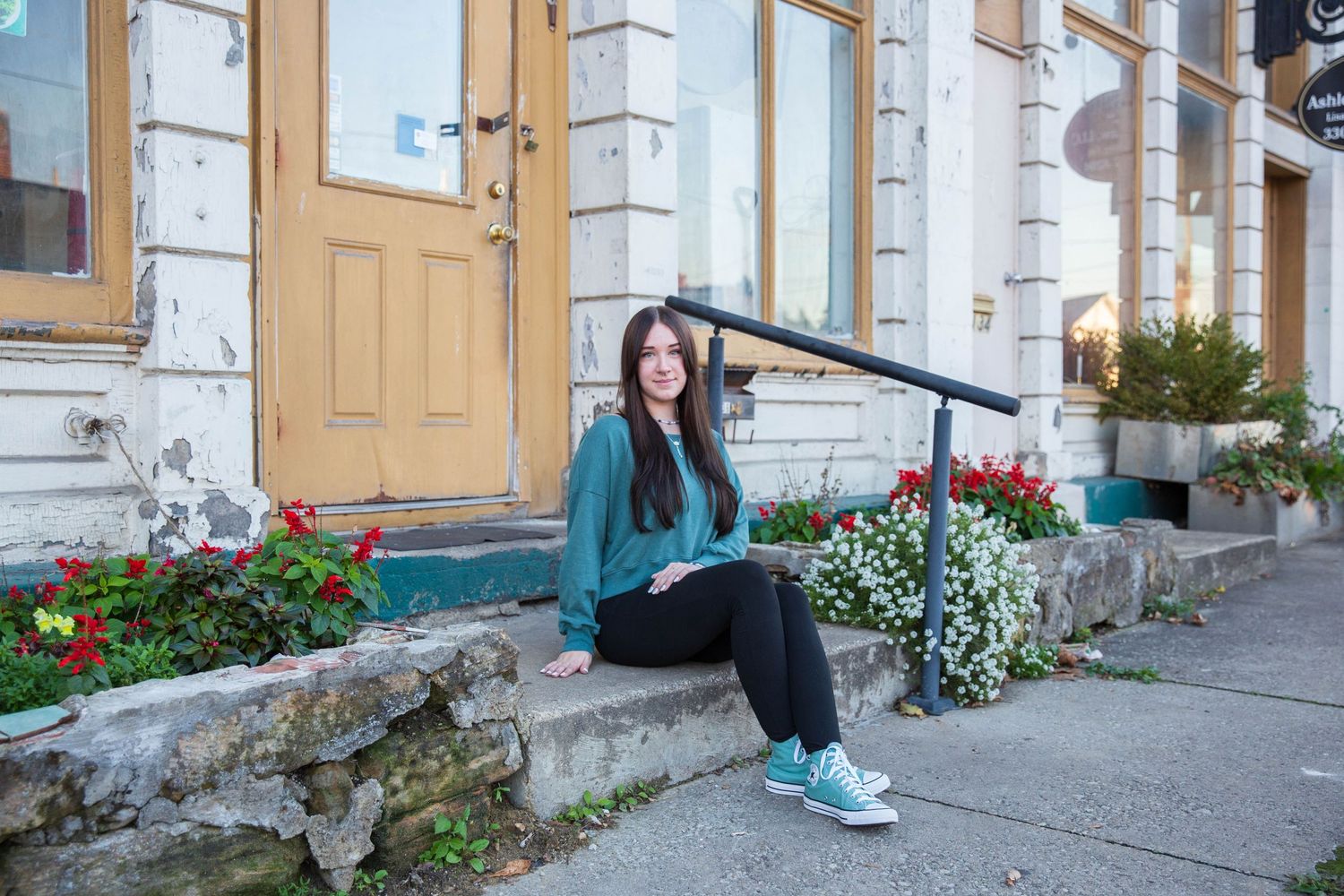 Casual outdoor photo series in front of a building with wooden doors and white trim.