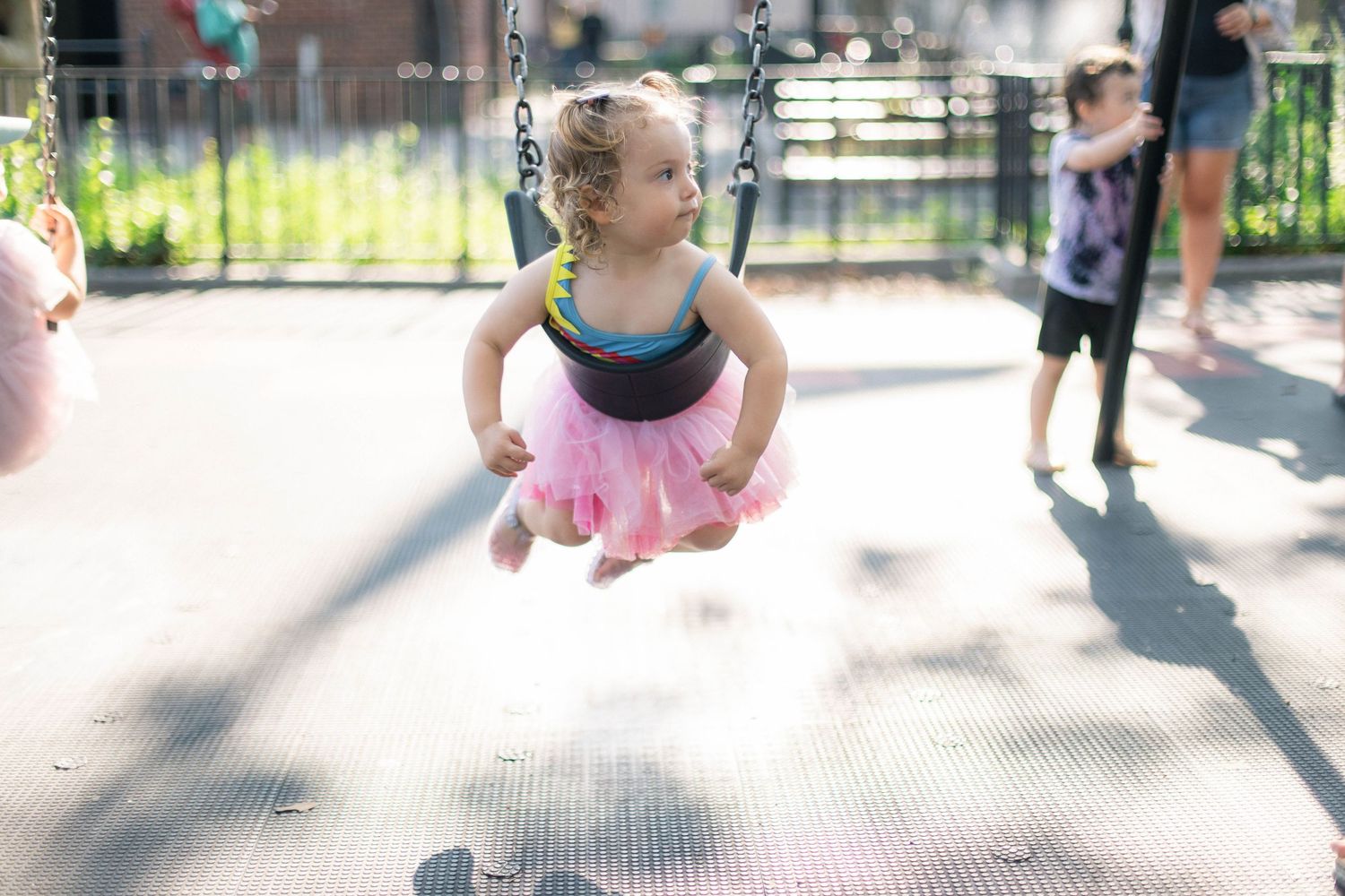 Candid, playful family photography. child on swing
