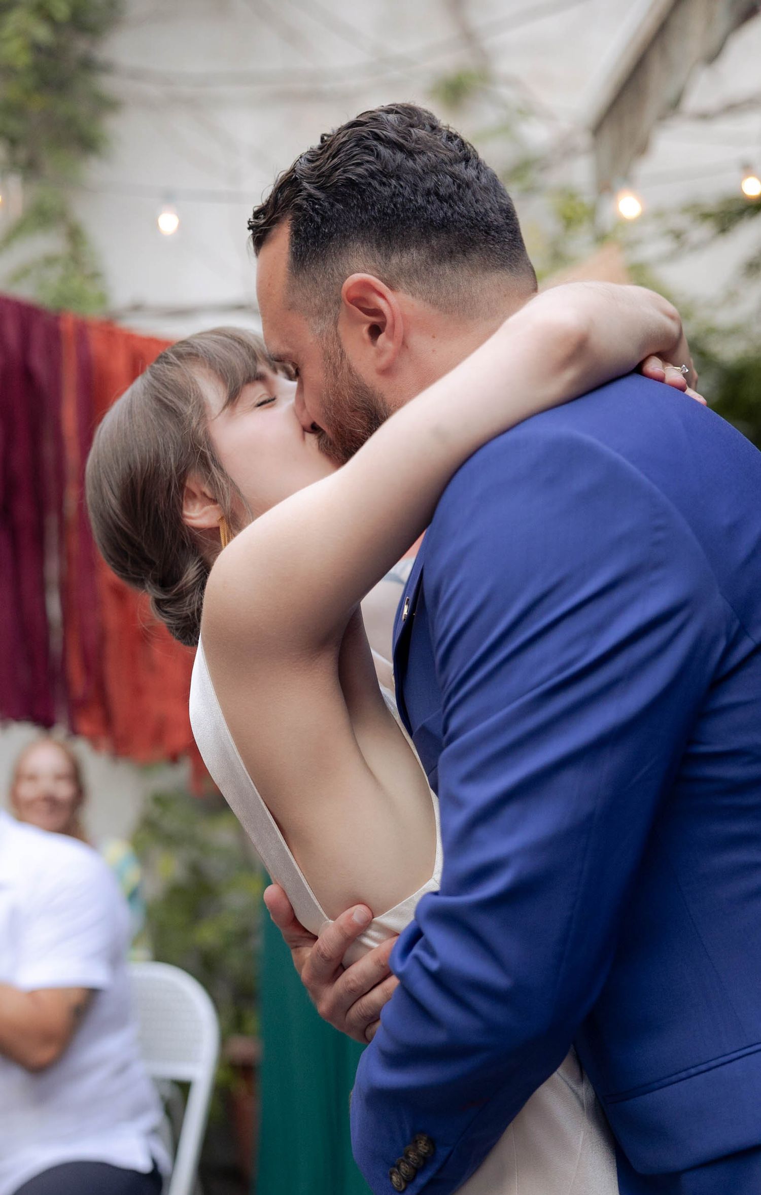 the big moment, the wedding kiss, colorful and candid fun photojournalist wedding, brooklyn. bride and groom not posing just enjoying