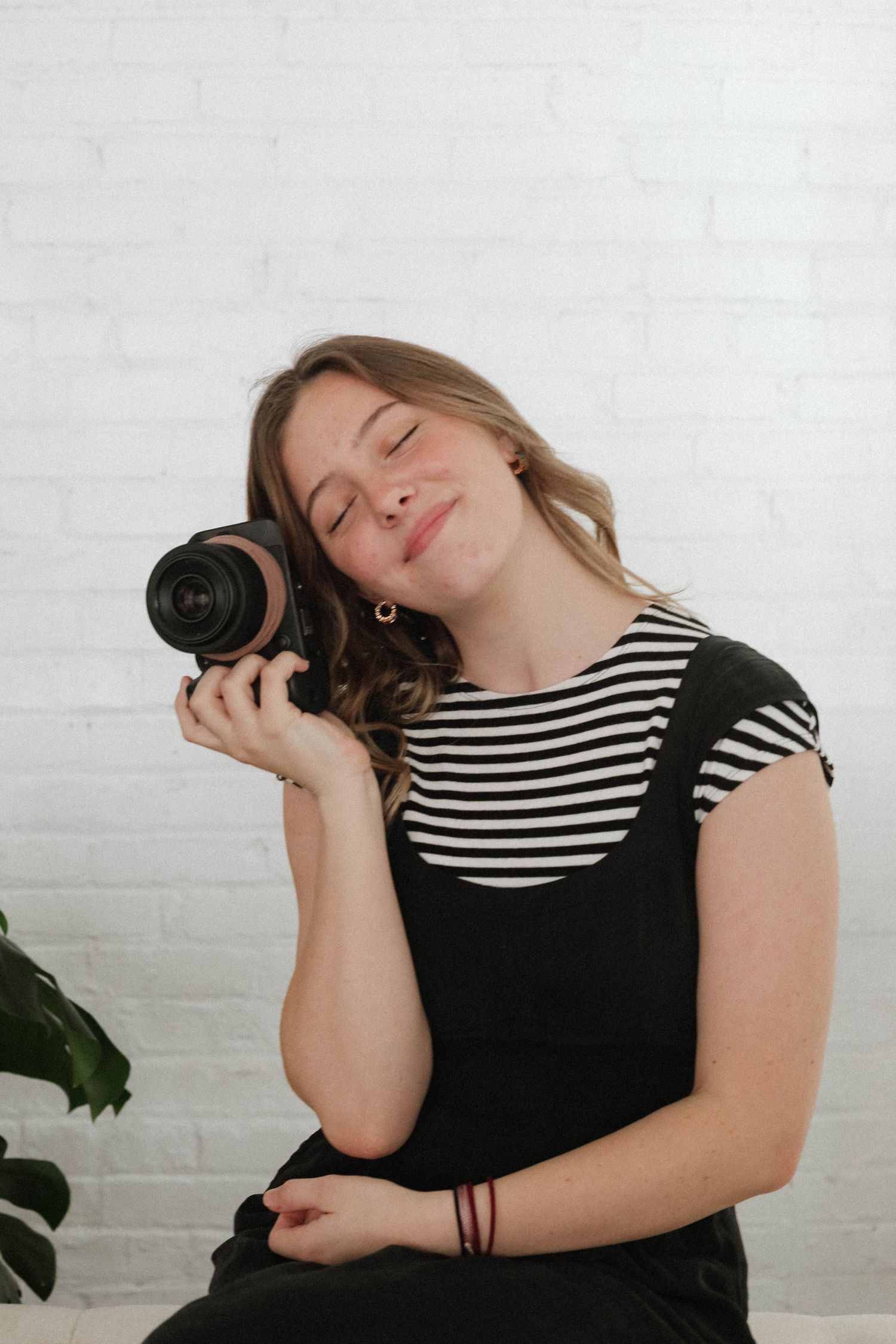 Wedding photographer Millie Frances holding a camera, serving couples in Southwest Virginia, Tennessee, and North Carolina