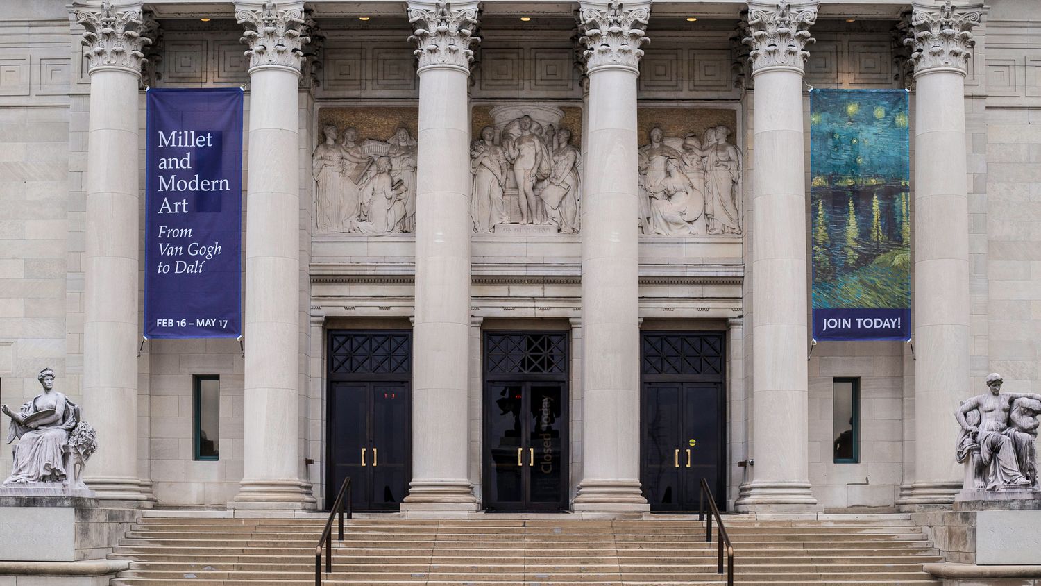 Neoclassical museum facade with grand columns, stone steps, and banners advertising Millet and Modern Art Van Gogh exhibition.