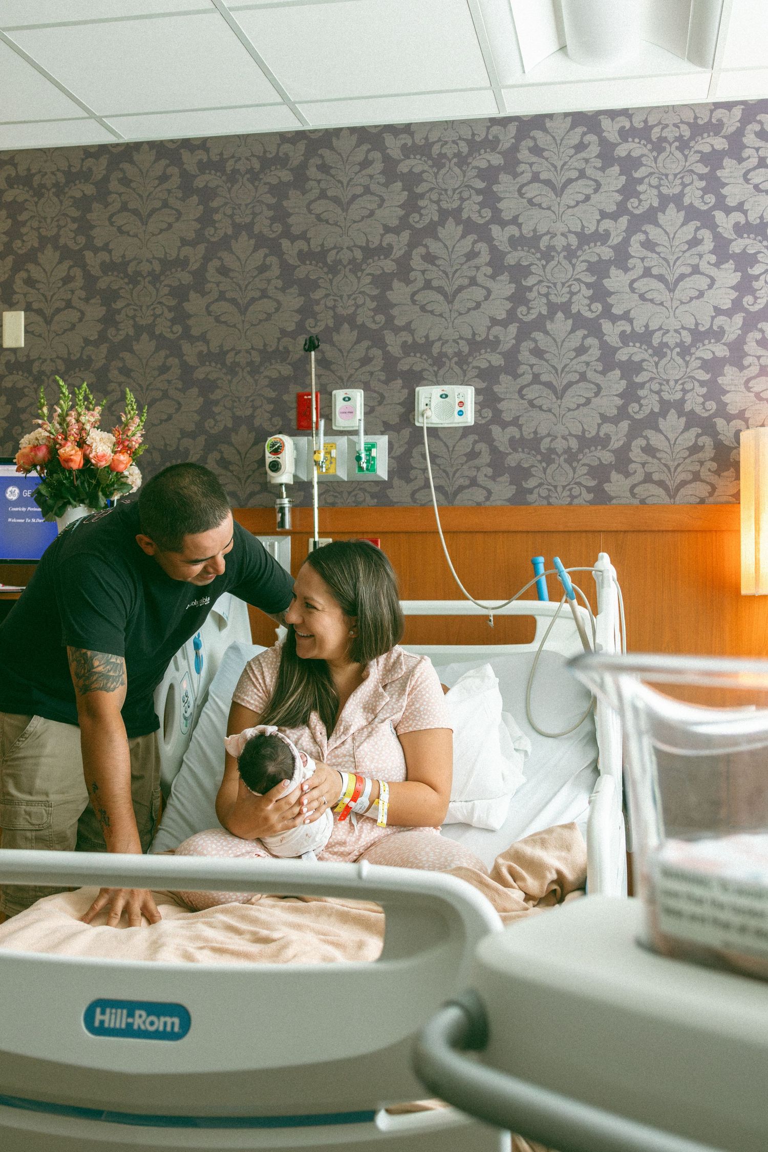 An Austin Texas Fresh 48 photo showing a tender moment between parents in a hospital room with medical equipment visible.