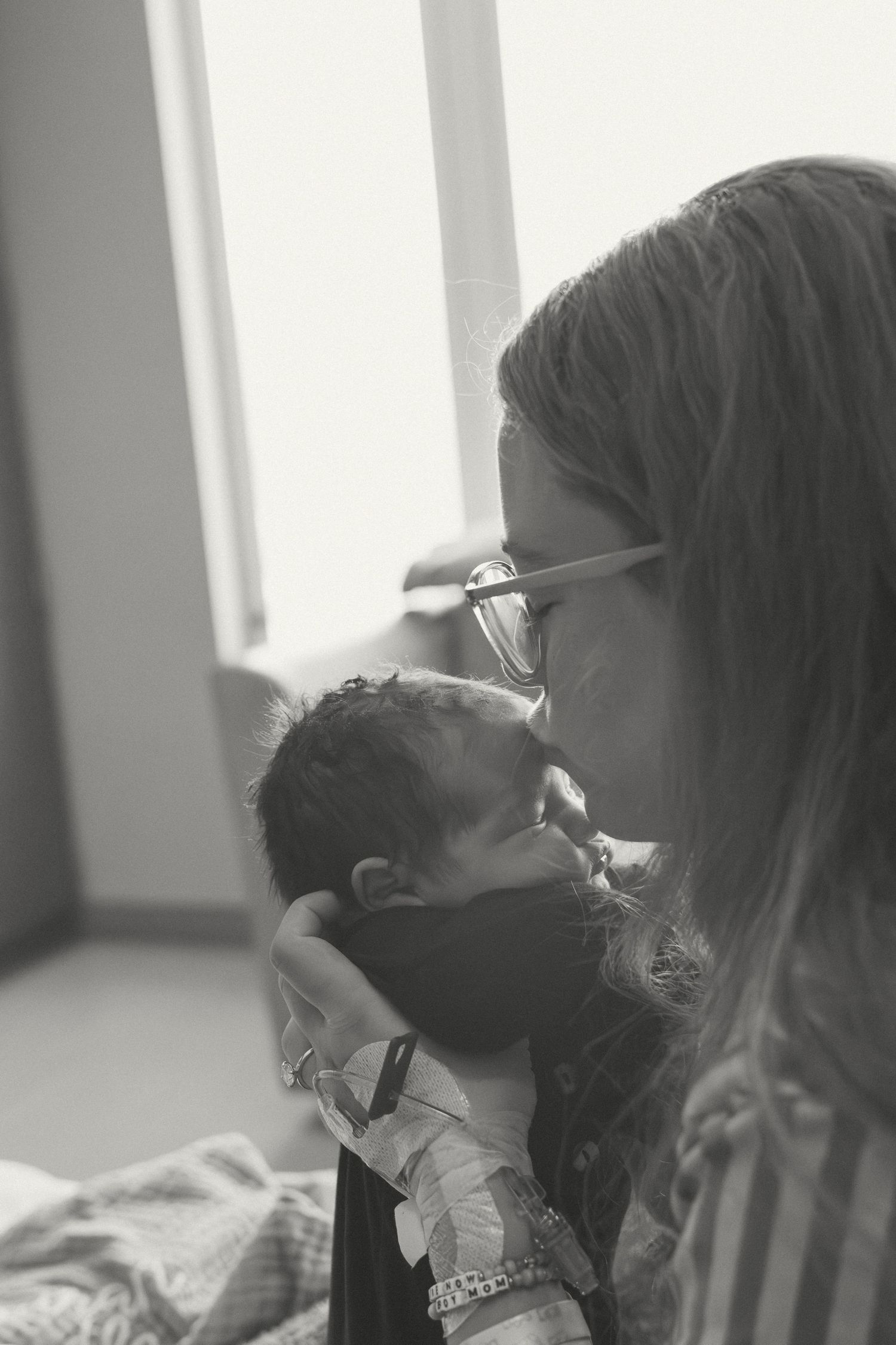 Black and white photo capturing gentle nurturing moments in the hospital's natural light.