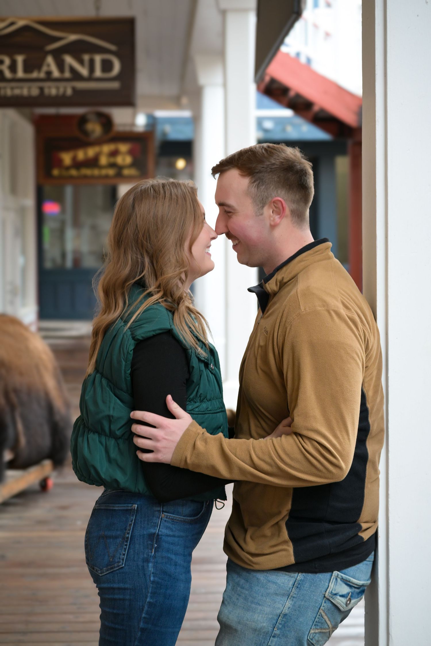 Intimate couple portrait on a small town storefront porch.