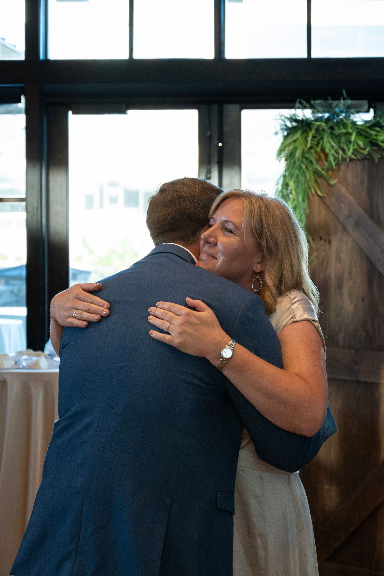A couple embraces during an emotional moment at their wedding reception.