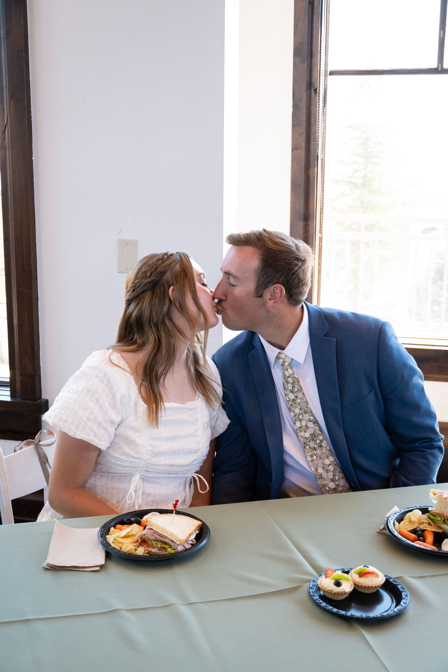 A romantic sequence of a couple sharing intimate moments across a dining table with plates of food.