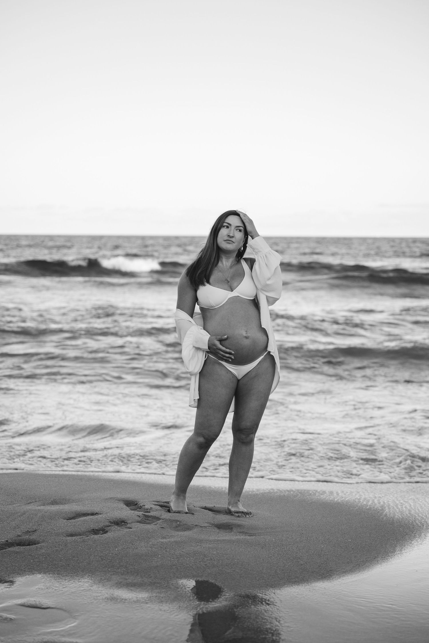Black and white photo series of someone posing on a beach at sunset with waves in the background.
