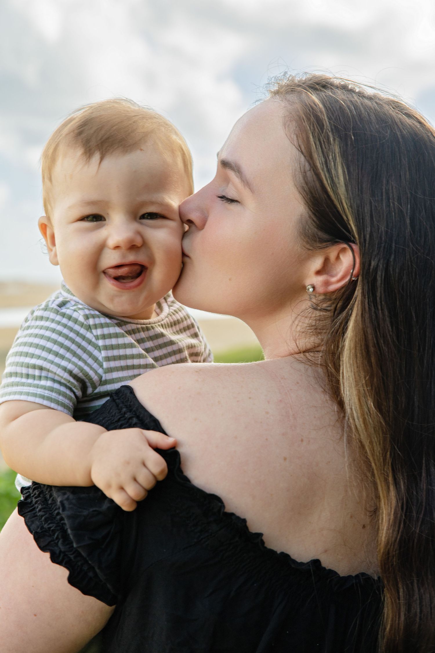 A tender moment of affection and laughter captured in a series of four candid outdoor photographs.