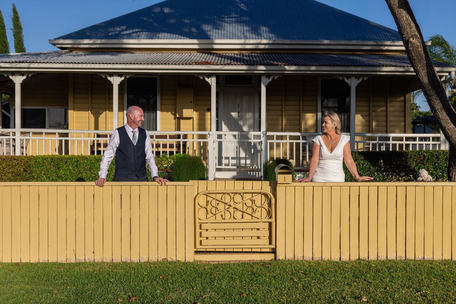 A row of outdoor wedding photos shows a gazebo, yellow fence, and garden setting in bright sunlight.