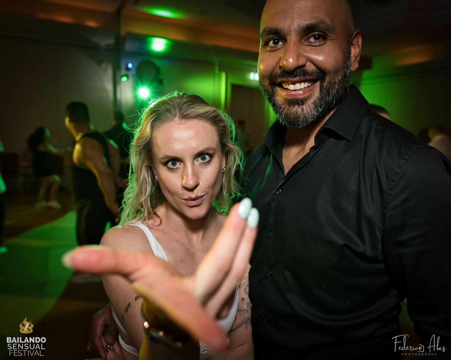 Dance partners striking an expressive pose during a social dance event.