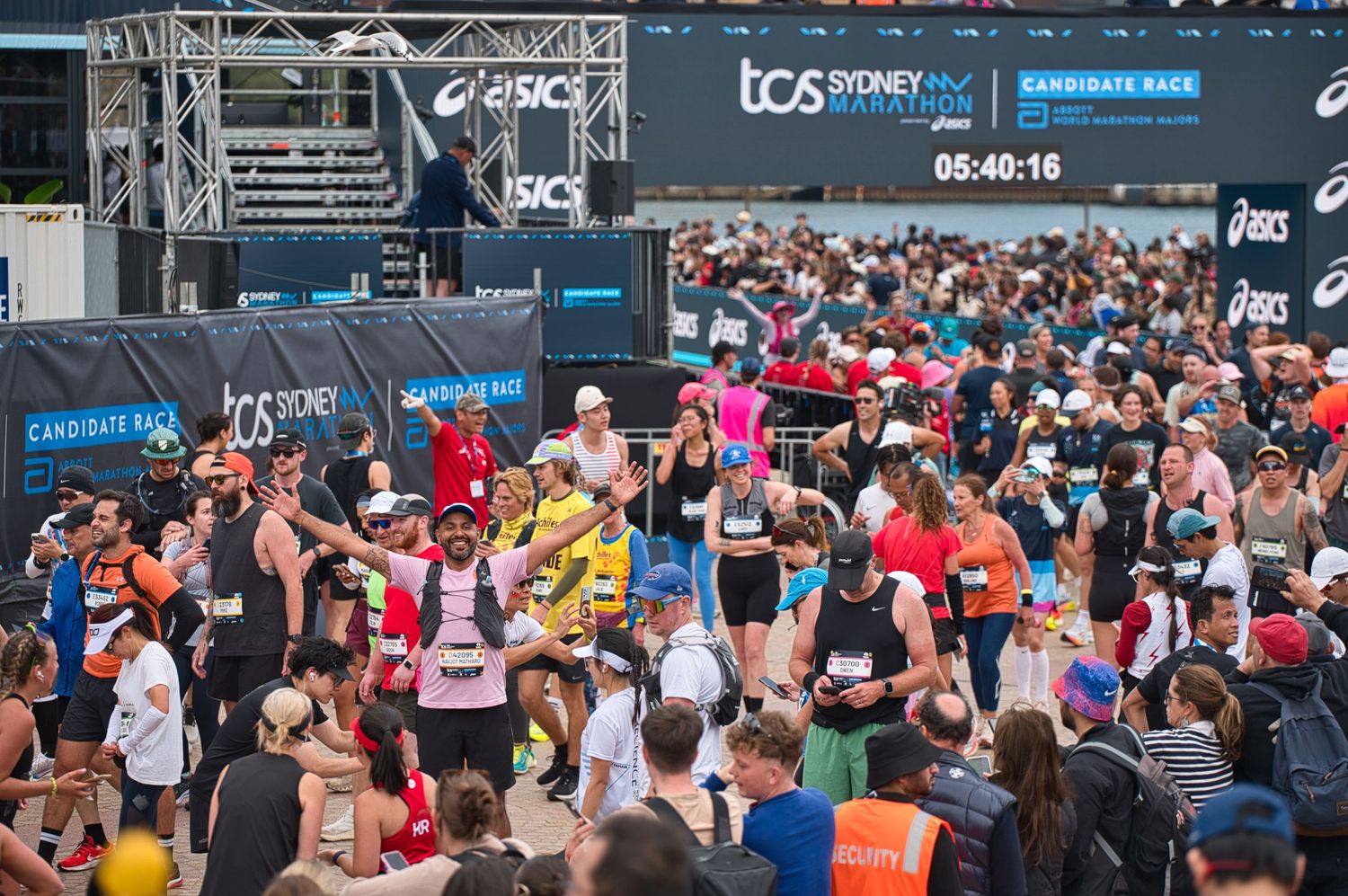 Large crowd of marathon participants gathered at UCS race event starting line.