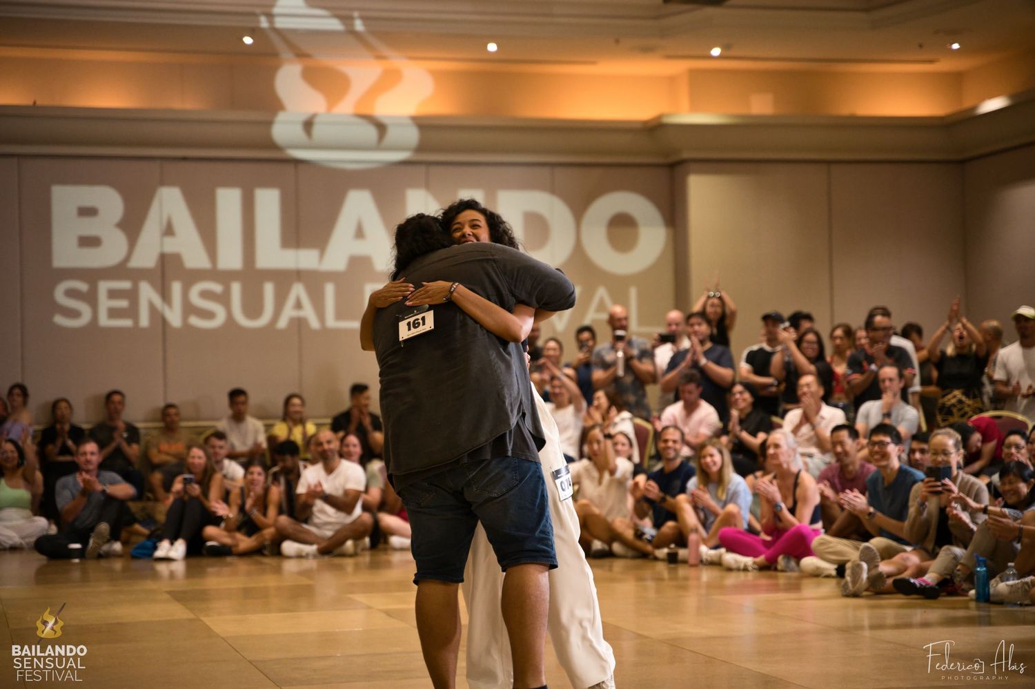 Dancers performing at Bailando festival with seated audience watching in the background.