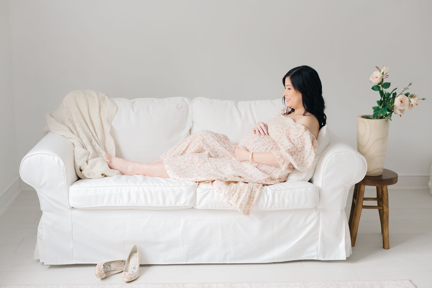 A series of soft pink and white bedding arrangements showing rumpled linens and pillows in a minimalist setting.