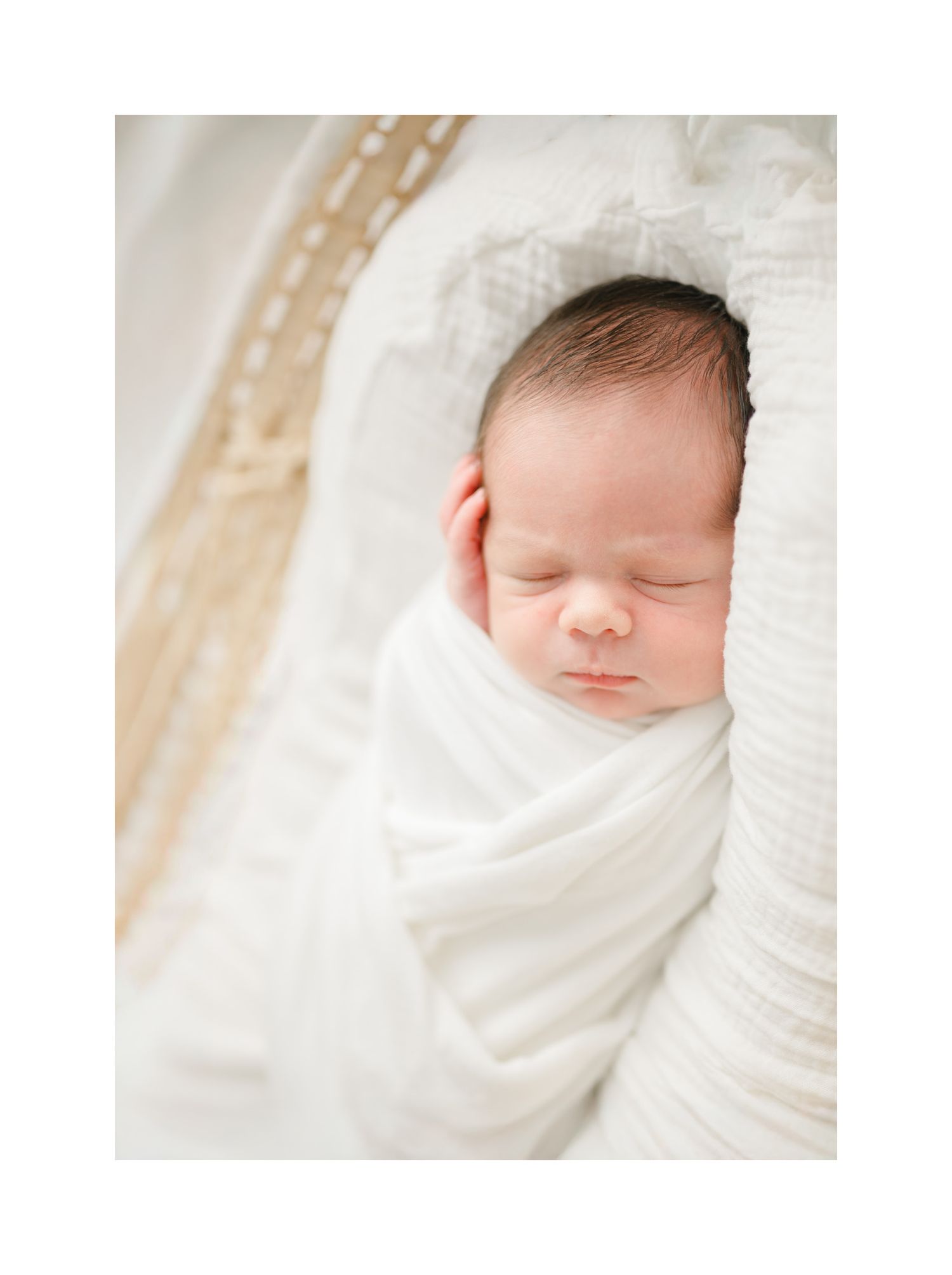 sweet sleeping newborn baby in Moses basket by Richmond newborn photographer