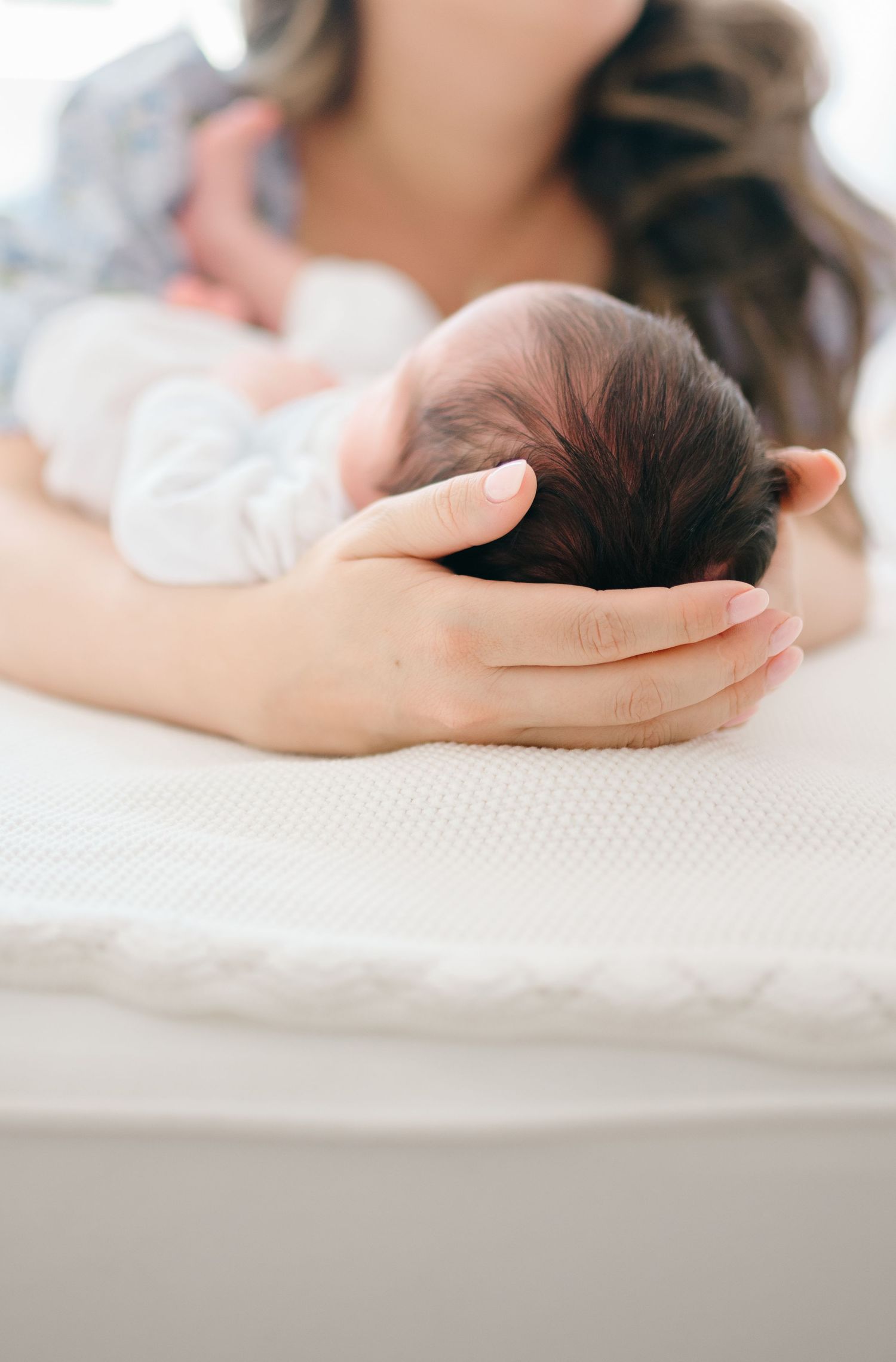 Mother holds her newborn baby in a Richmond Virginia family photography session