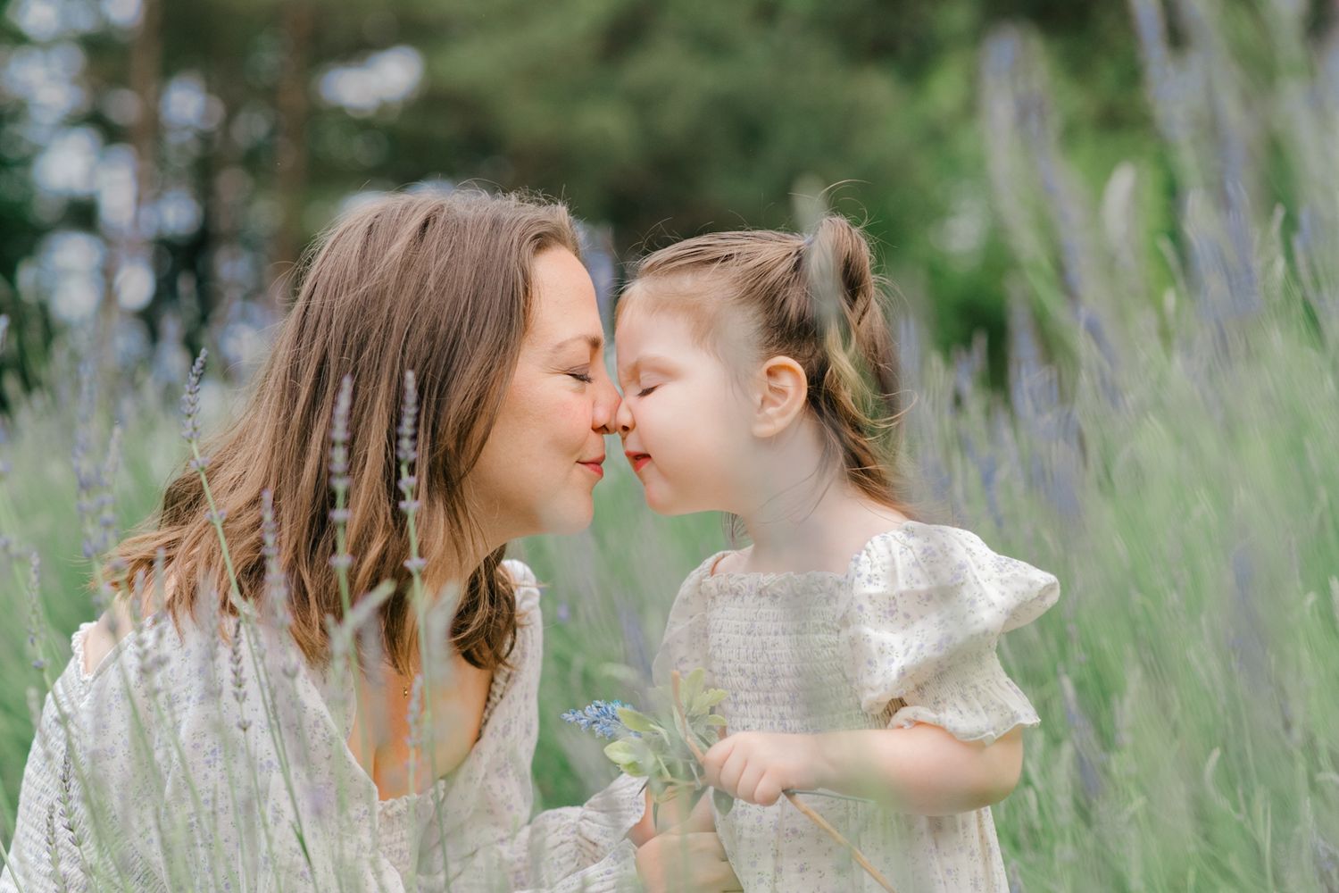 Intimate moment captured in tall grass field during golden hour.