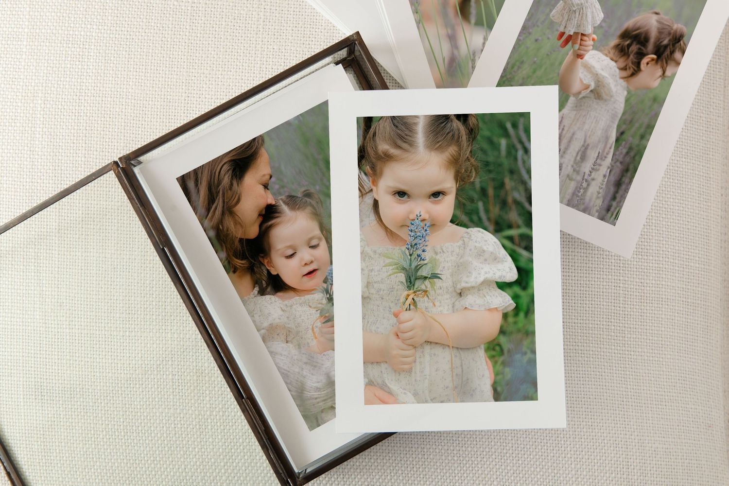 A collection of vintage-style polaroid photographs arranged in an artistic layout on a light colored surface.