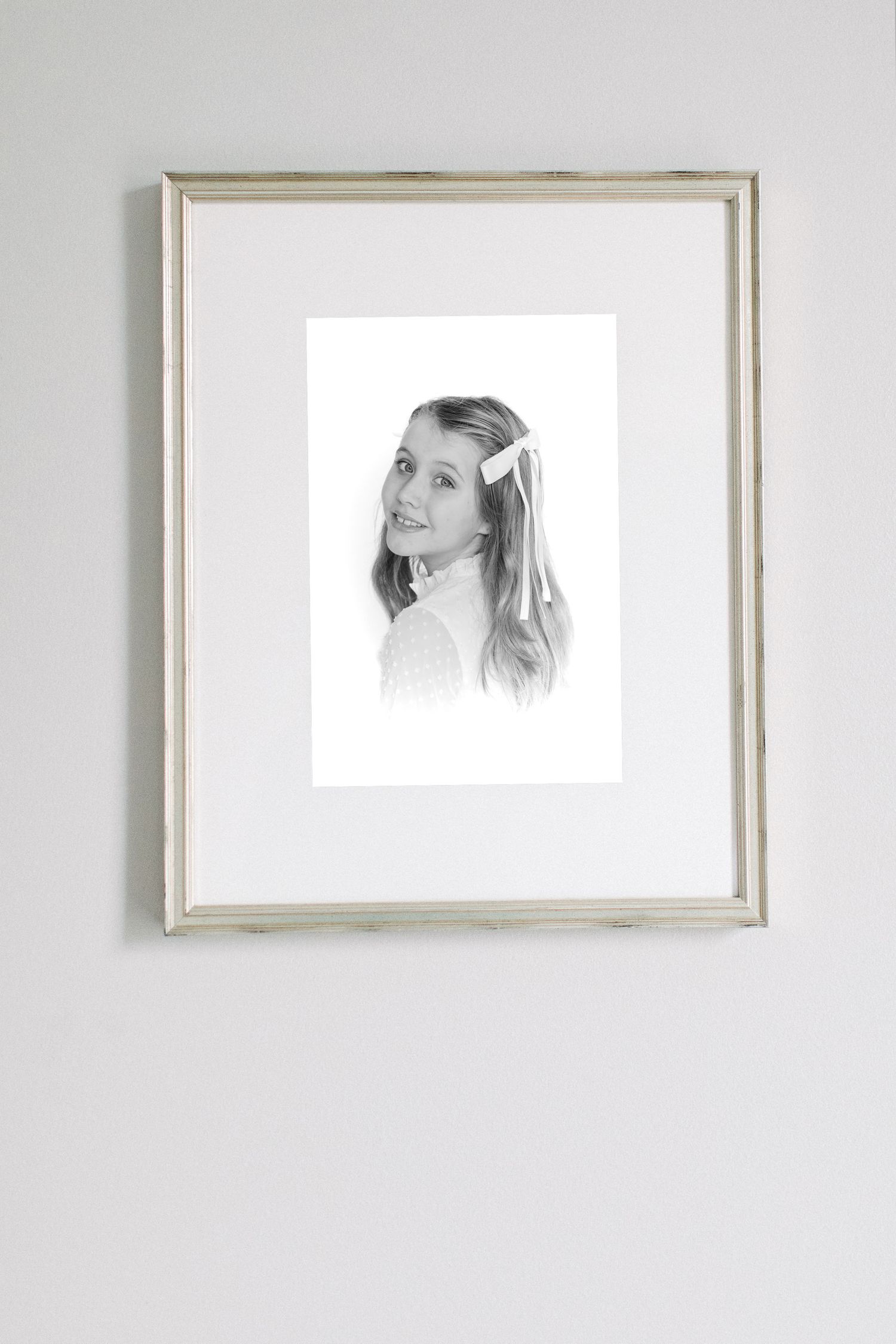 Series of minimalist framed portraits displayed on a white wall.