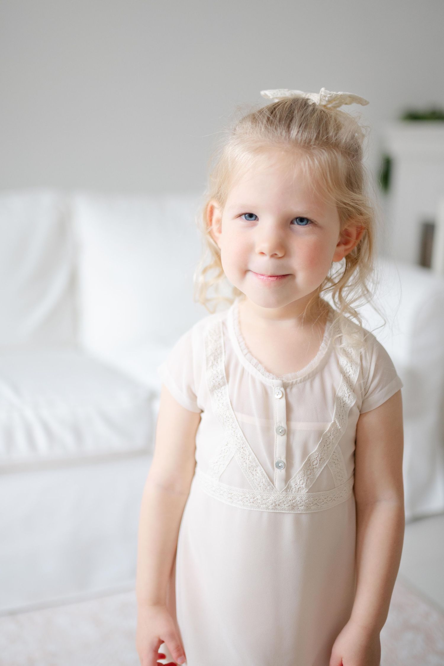 A toddler stares at the camera in Moseley Photography studio .