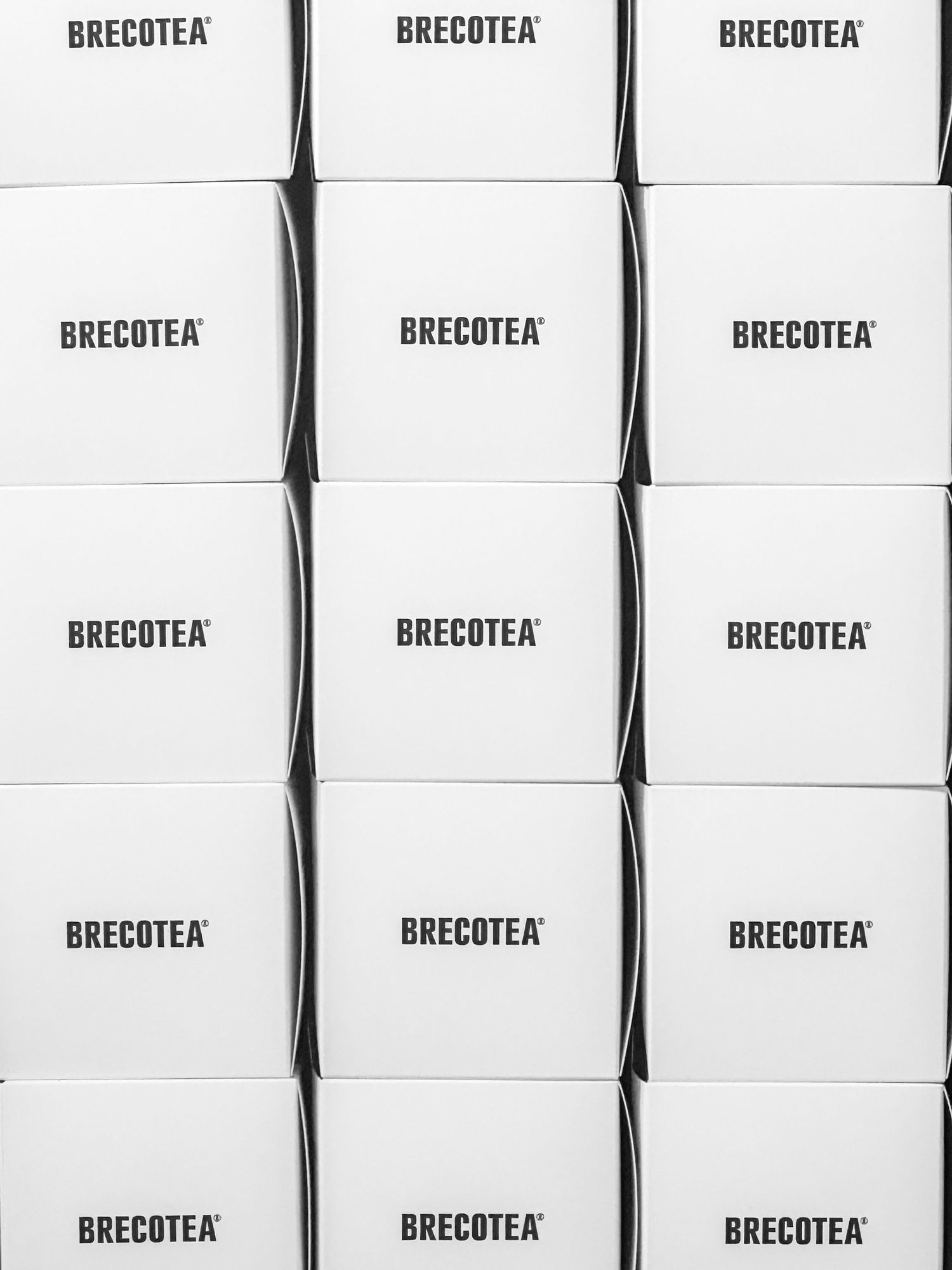 Rows of white BRECOTEA branded boxes stacked in a repeating pattern.