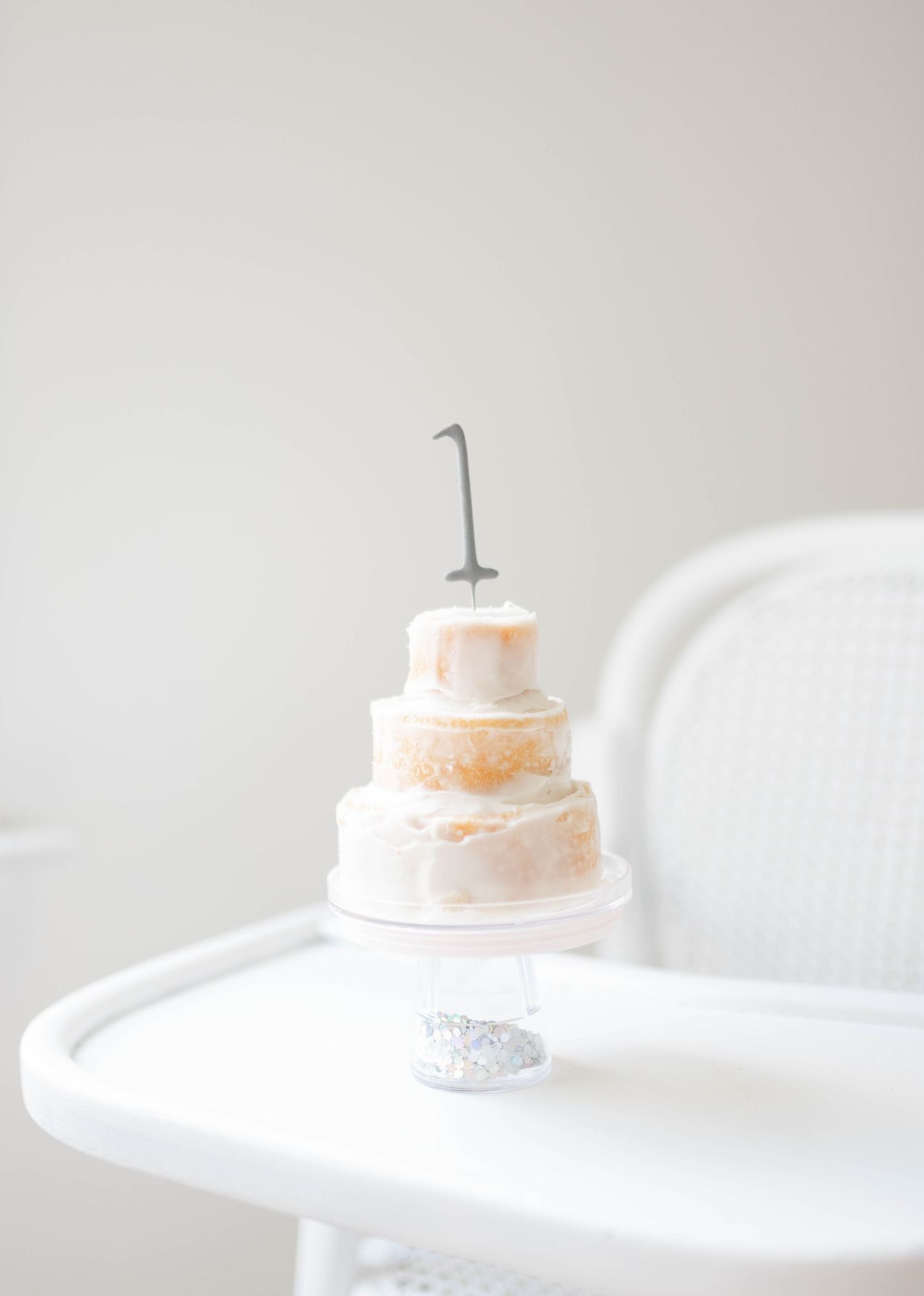 A white ceramic cake stand is shown in multiple angles against a light gray background.