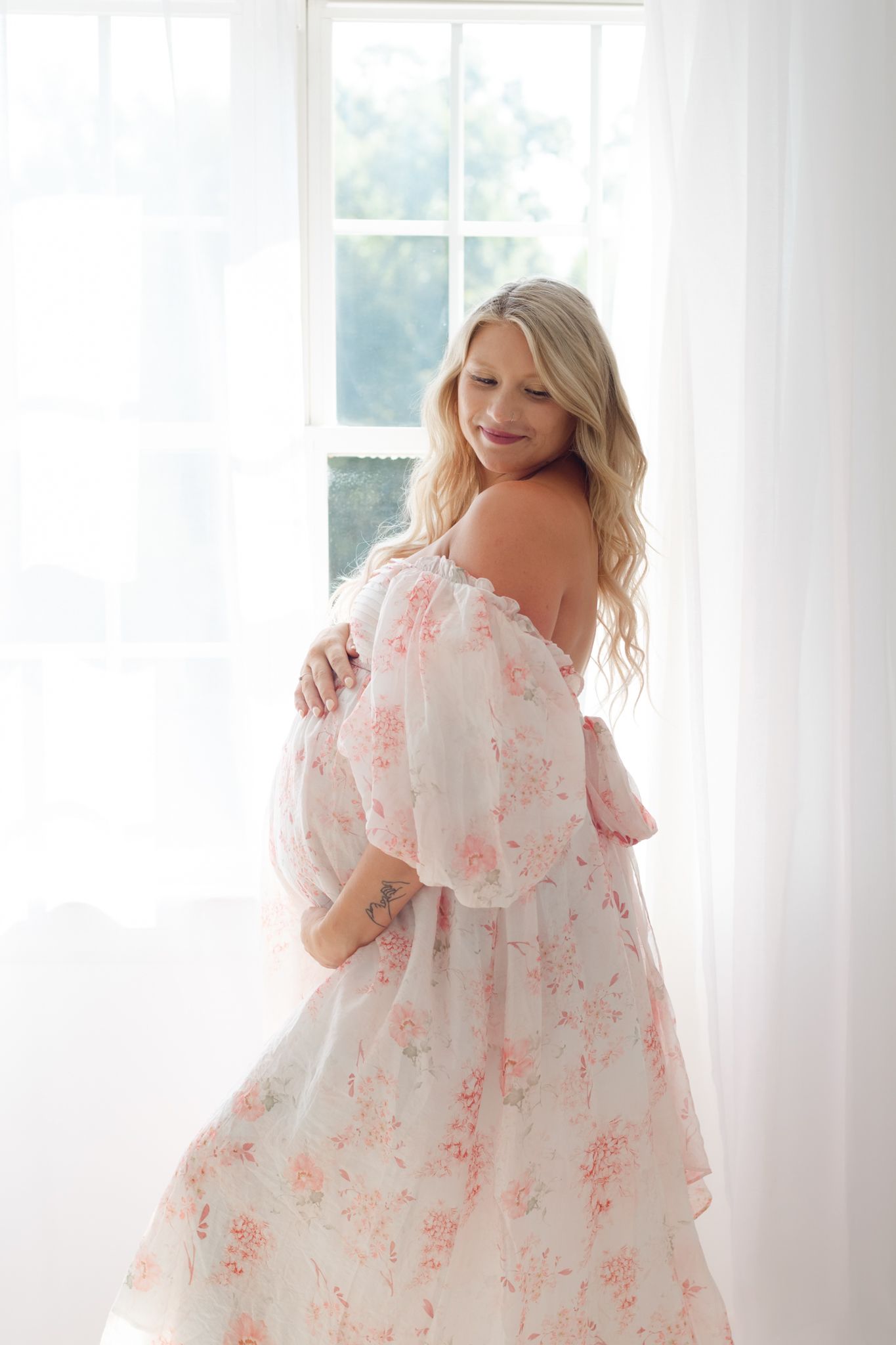 Pregnant mother during a maternity photography session in a natural light studio in Chesterfield, Virginia
