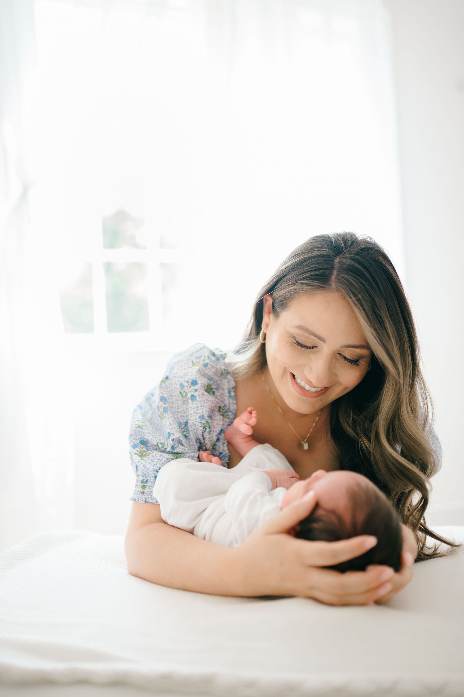 Mother holds her newborn in a Midlothian Virginia newborn photography session