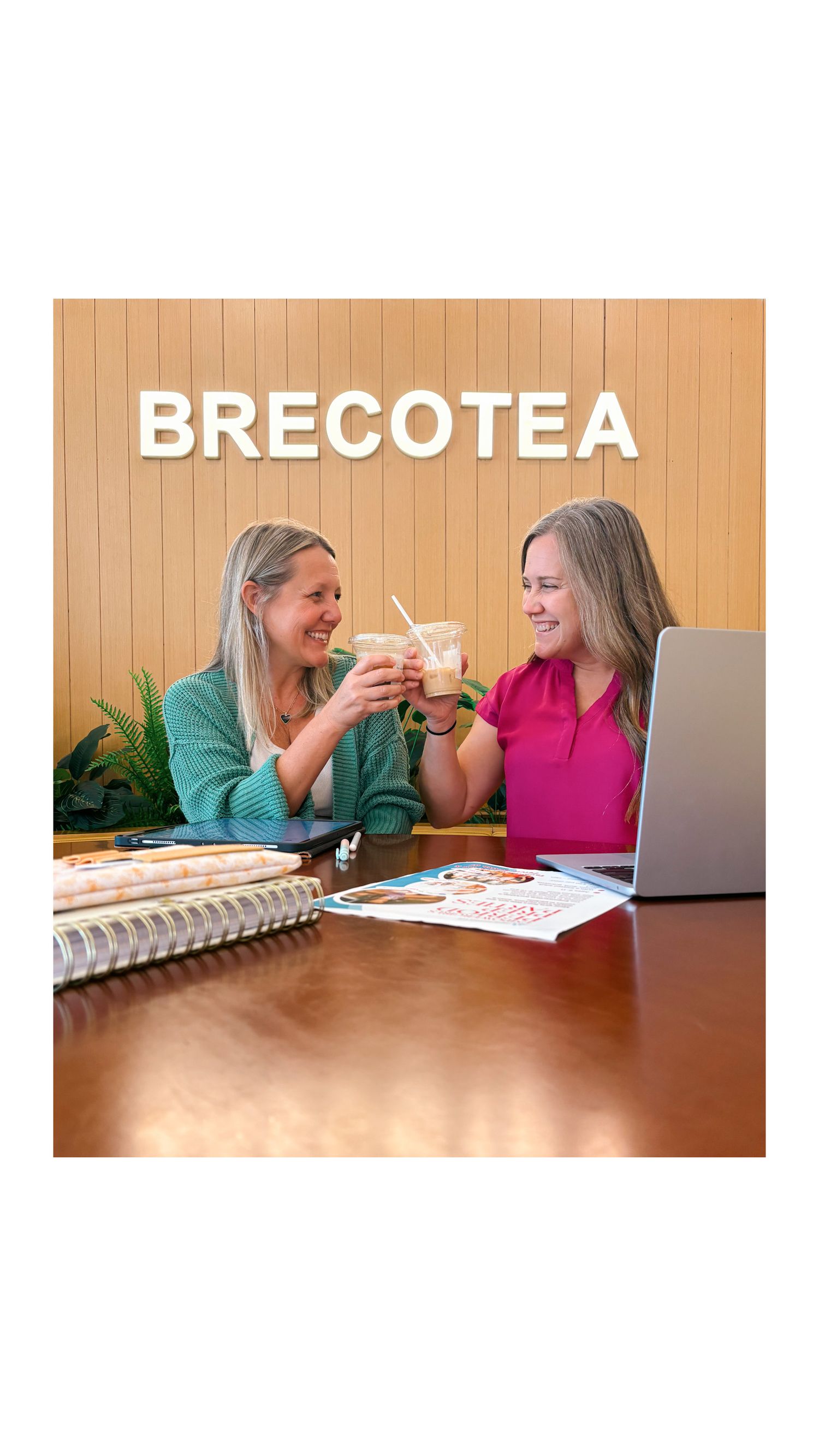People seated at a wooden table with BRECOTEA branding in view.