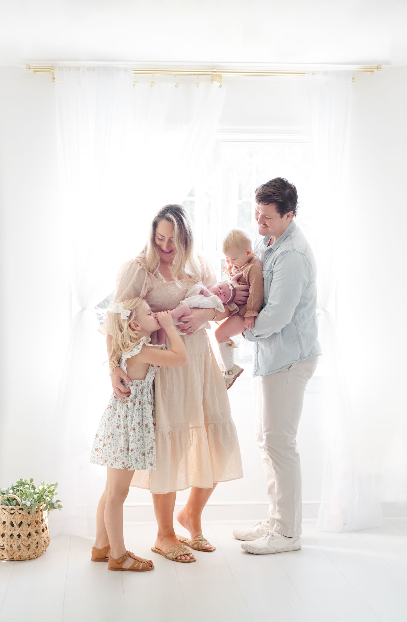 Family gathering in white room sharing joyful moments together.