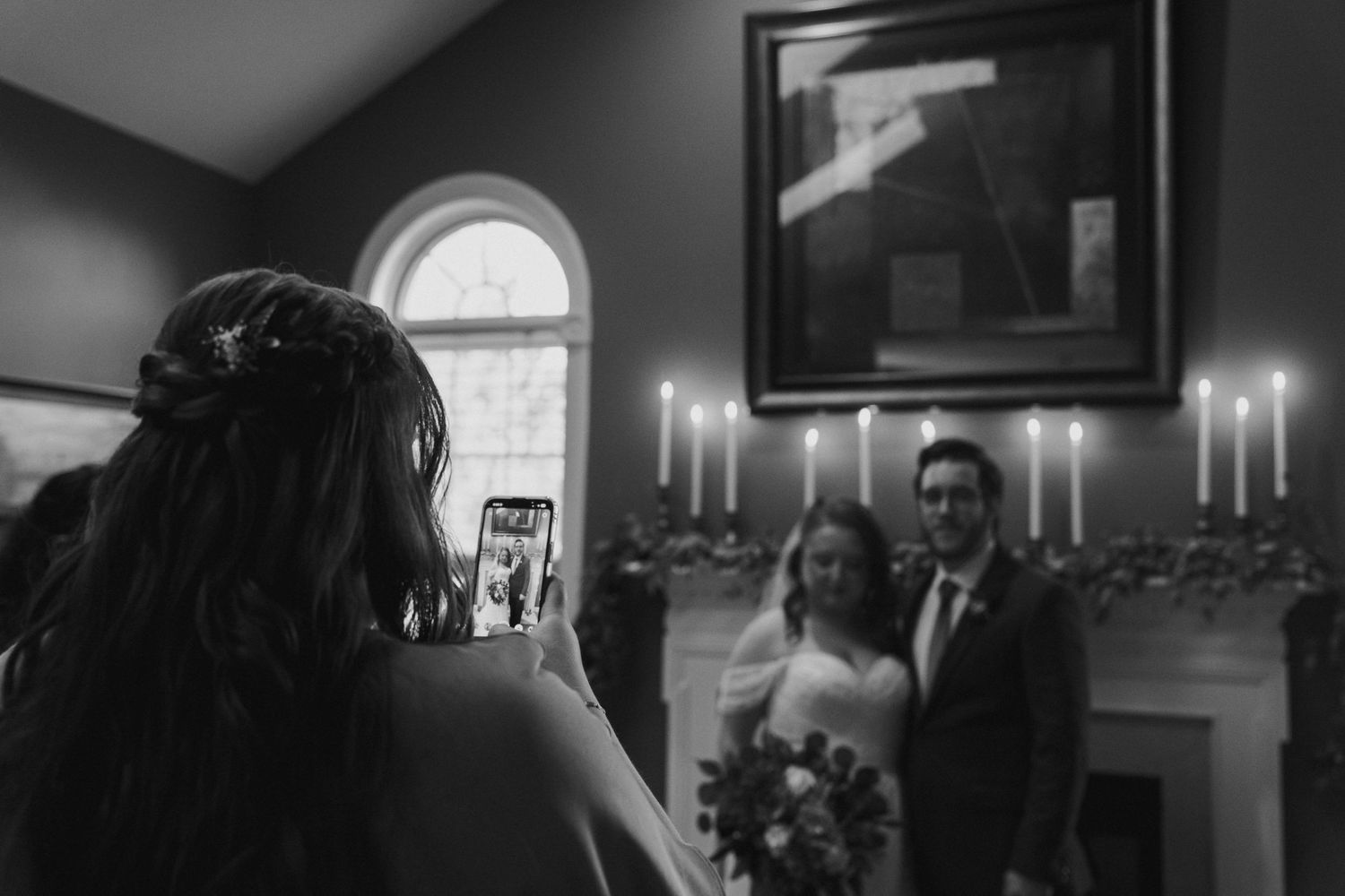 A candlelit indoor setting captured in black and white during a wedding photo session.