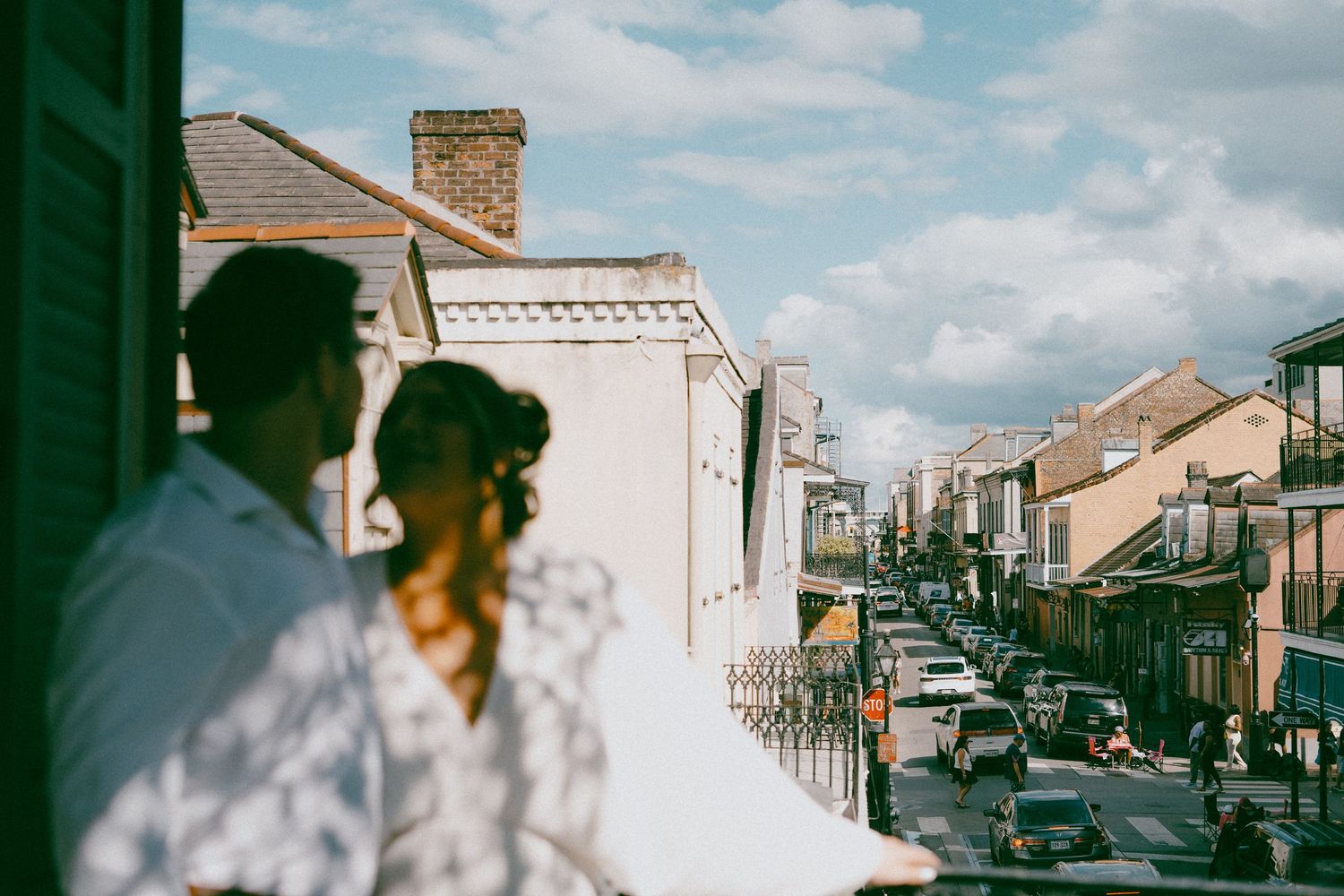 Film strip of vintage streetscapes showing old cars and buildings under blue skies in a busy town.