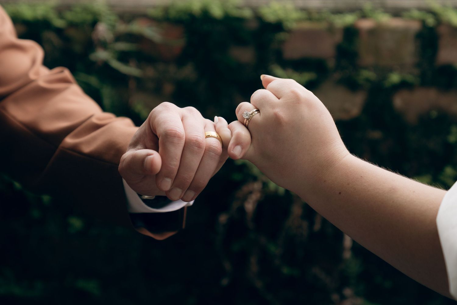 A close-up shot shows gentle hands releasing an origami paper crane on a dark background.