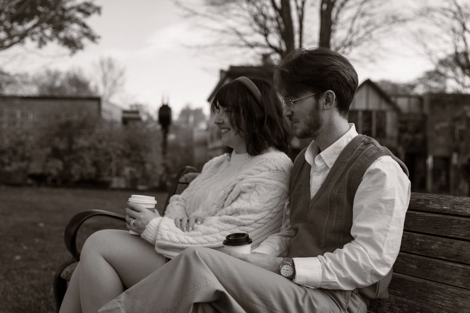 A romantic black and white photo series showing intimate moments between a couple on a park bench. Couple in Bar Harbor Maine
