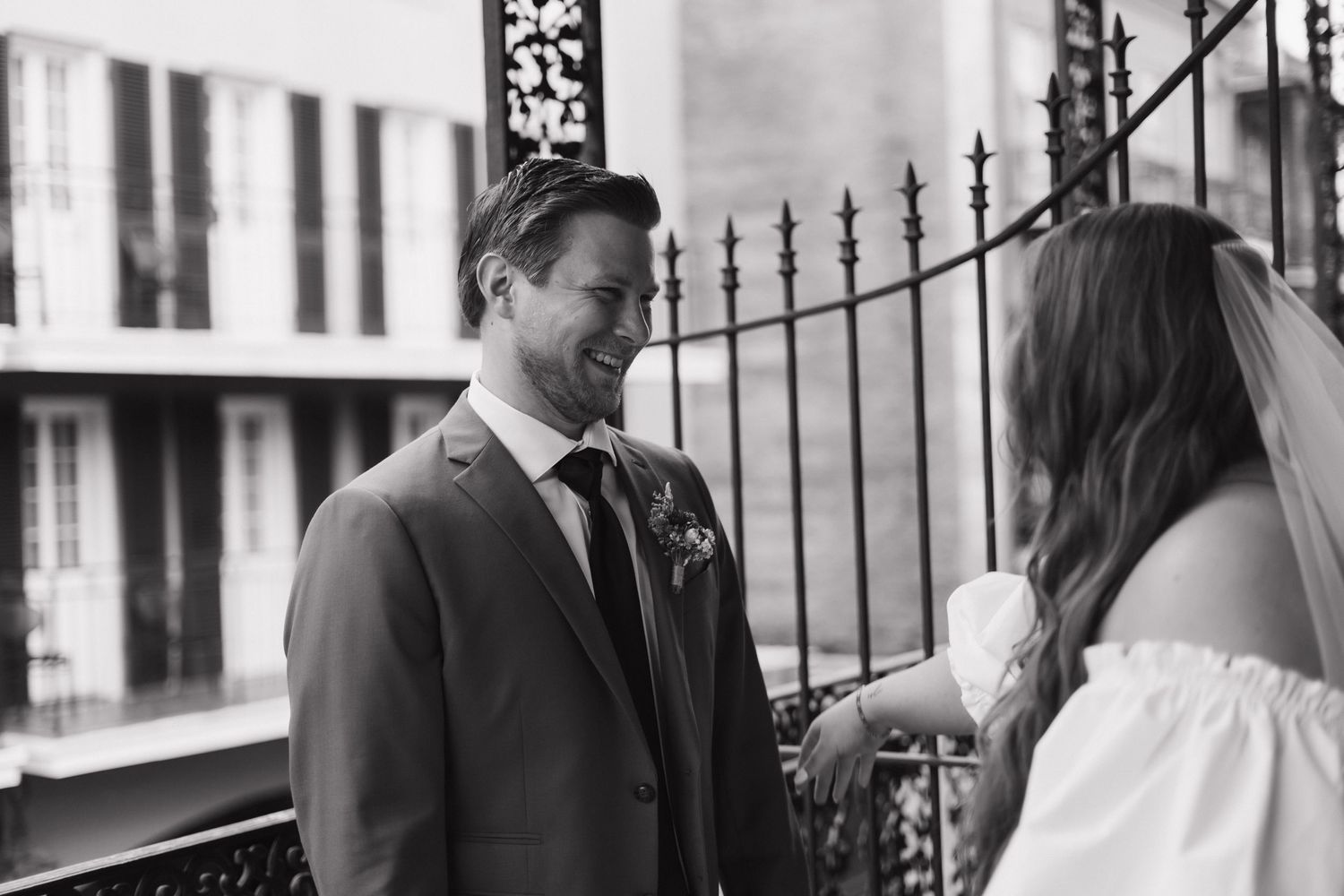 A tender moment between newlyweds during their wedding ceremony, captured in black and white photography.