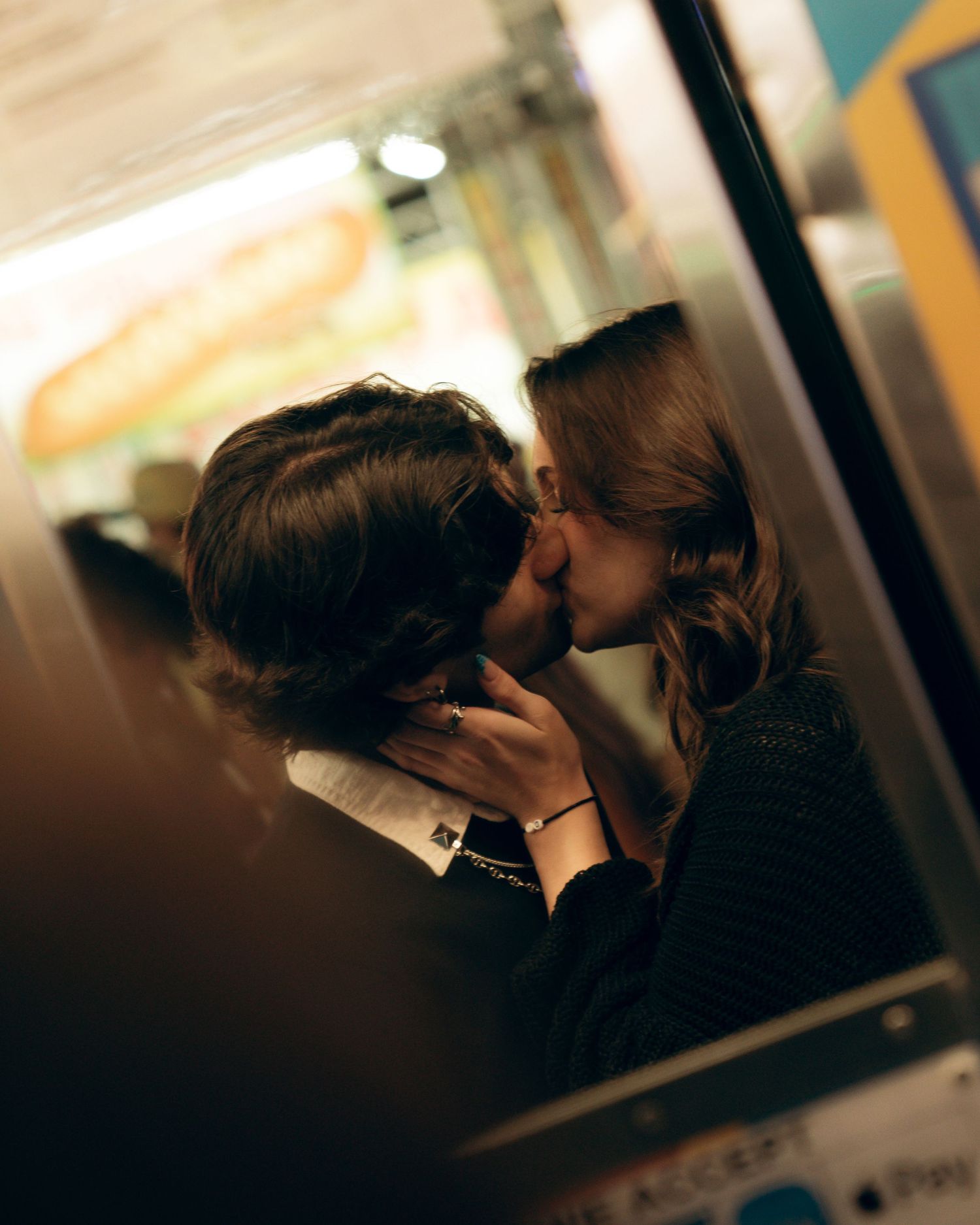 A silhouetted couple sharing an intimate moment in dim lighting.