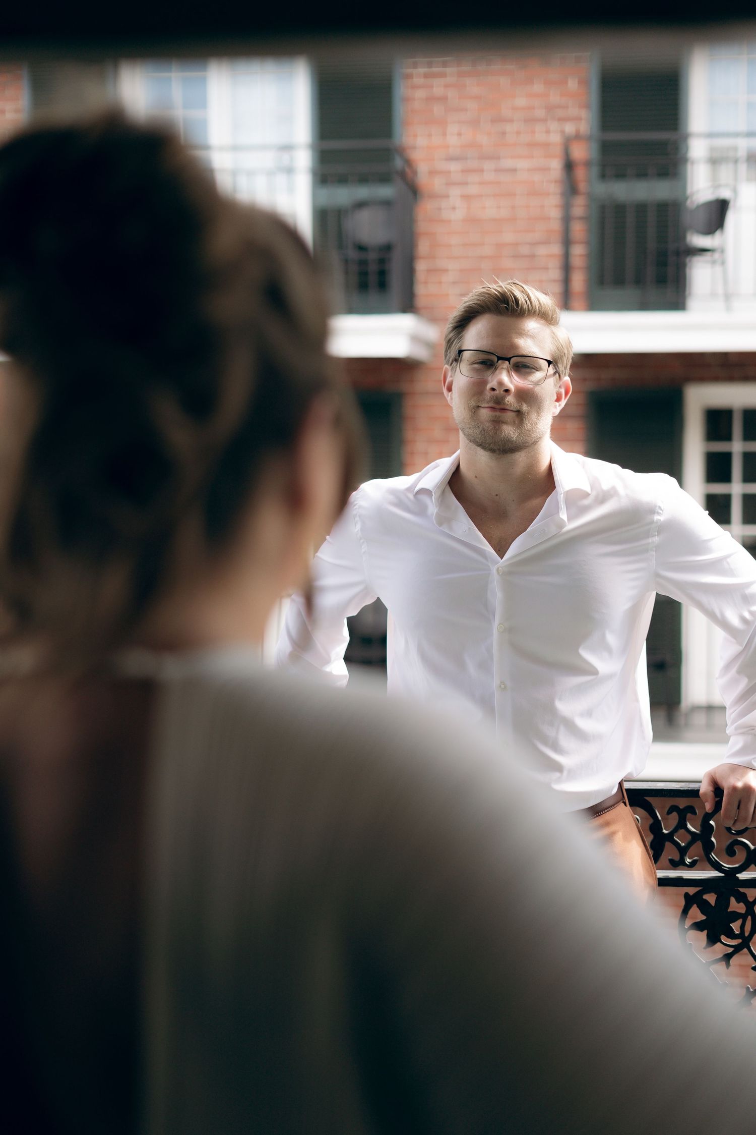 A series of blurred profile views against a brick wall background showing shifting focus and depth of field.