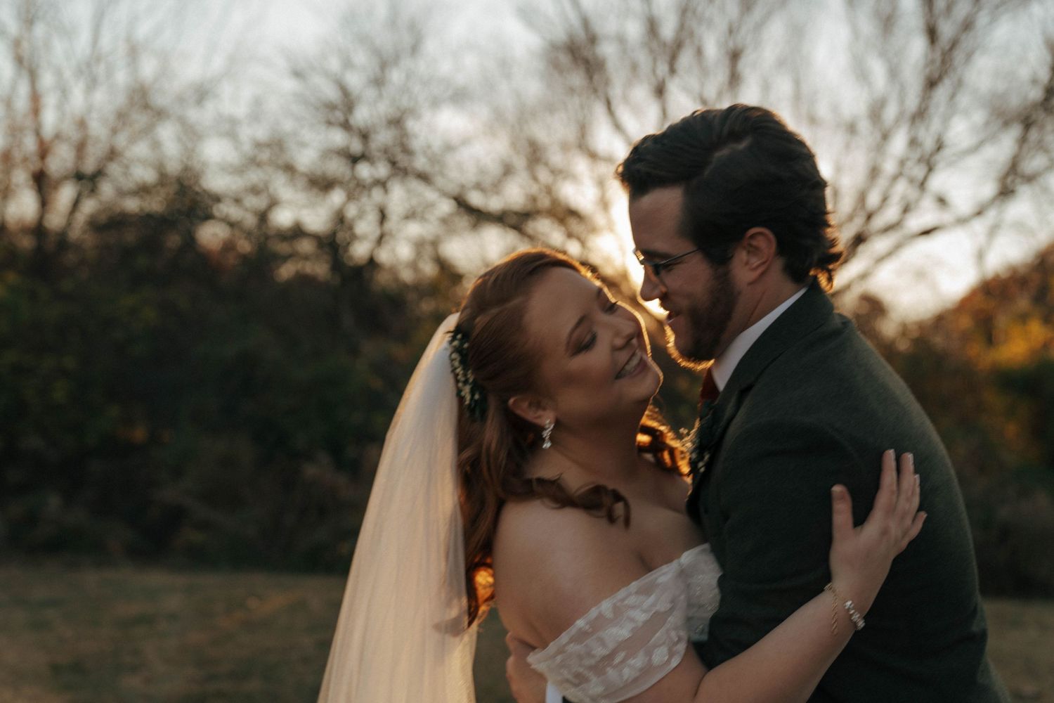 Romantic sunset wedding portrait with golden backlight.