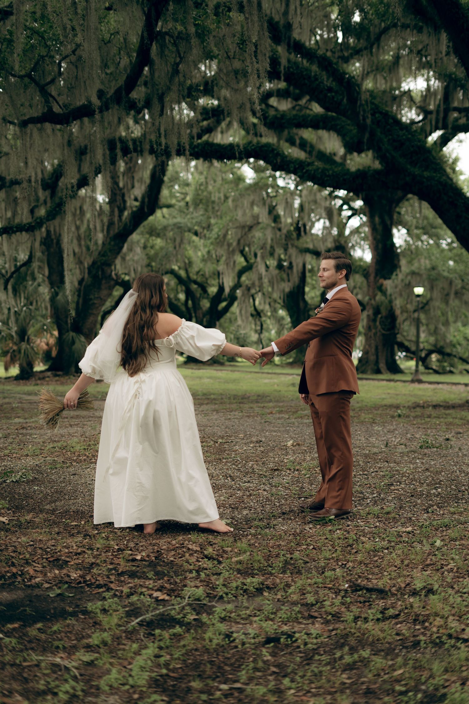 A sequence of ethereal dance movements captured under moss-draped oak trees in a mystical outdoor setting.
