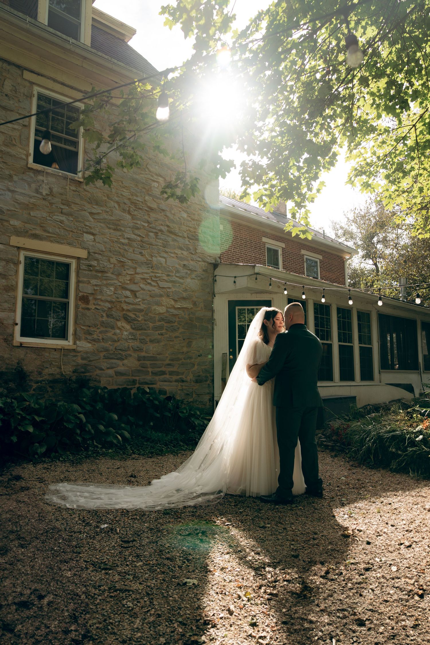 A romantic wedding photo sequence showing a couple in formal attire against a stone building in dappled sunlight.