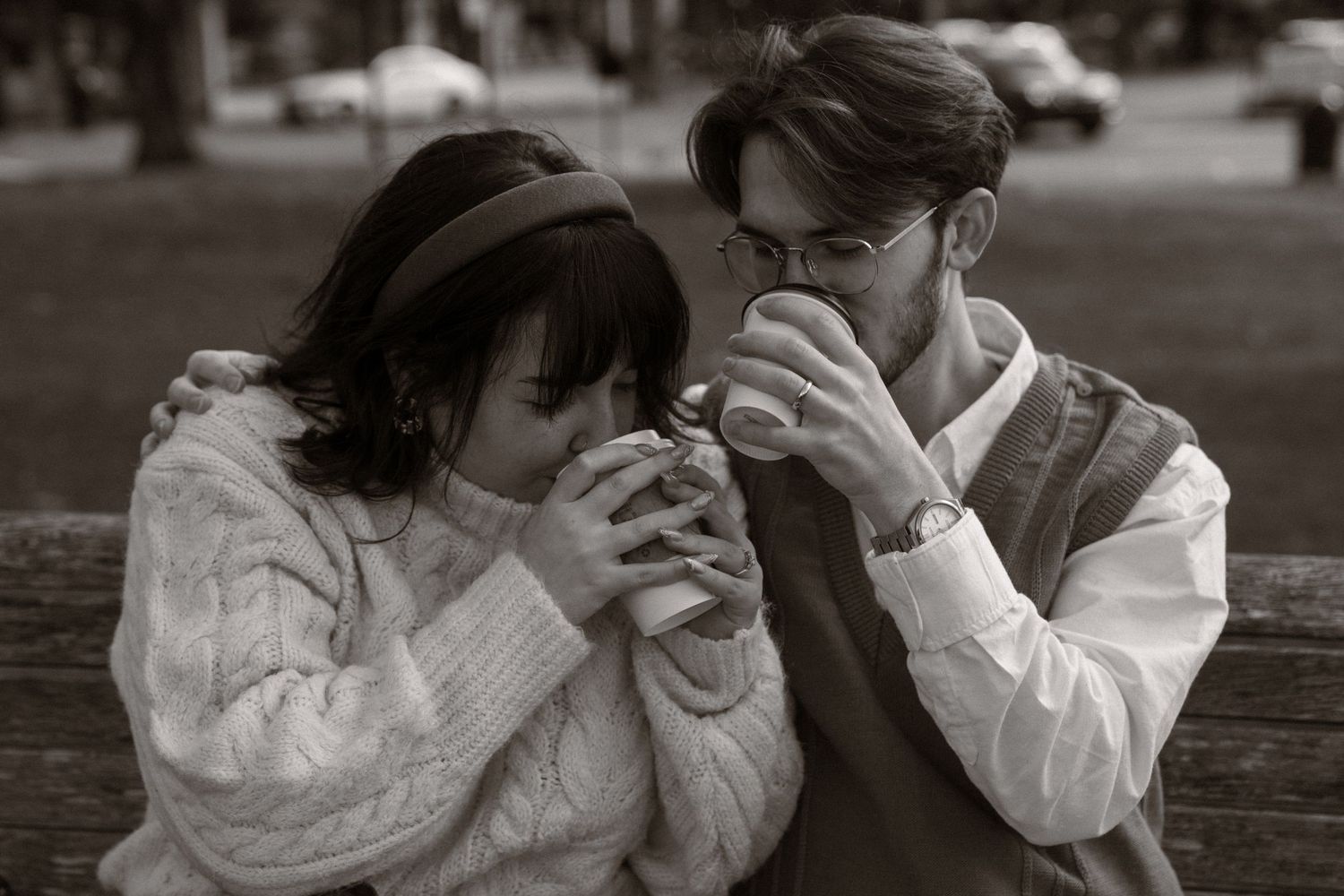 A romantic black and white photo series showing a couple embracing and sharing tender moments in a park setting. Bar Harbor Maine