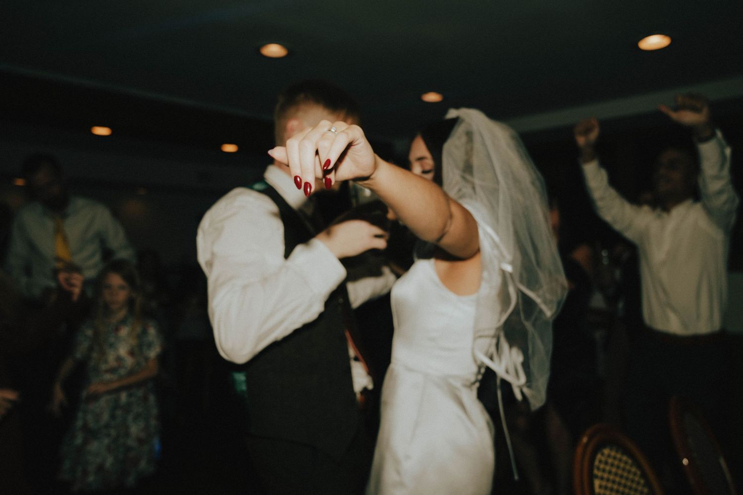 Newly married couple shares an intimate dance on their wedding reception dance floor.