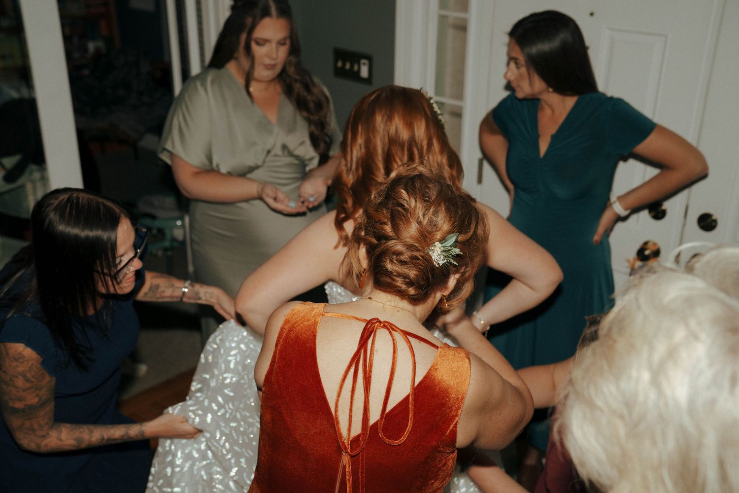 Wedding preparation scene with group gathered in casual attire.