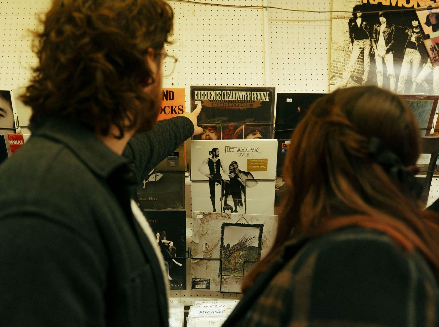 Students walk through a crowded school hallway between classes with lockers visible along the wall.
