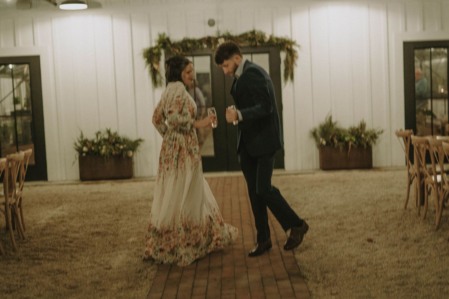 A romantic dance captured in vintage tones in a rustic indoor setting.